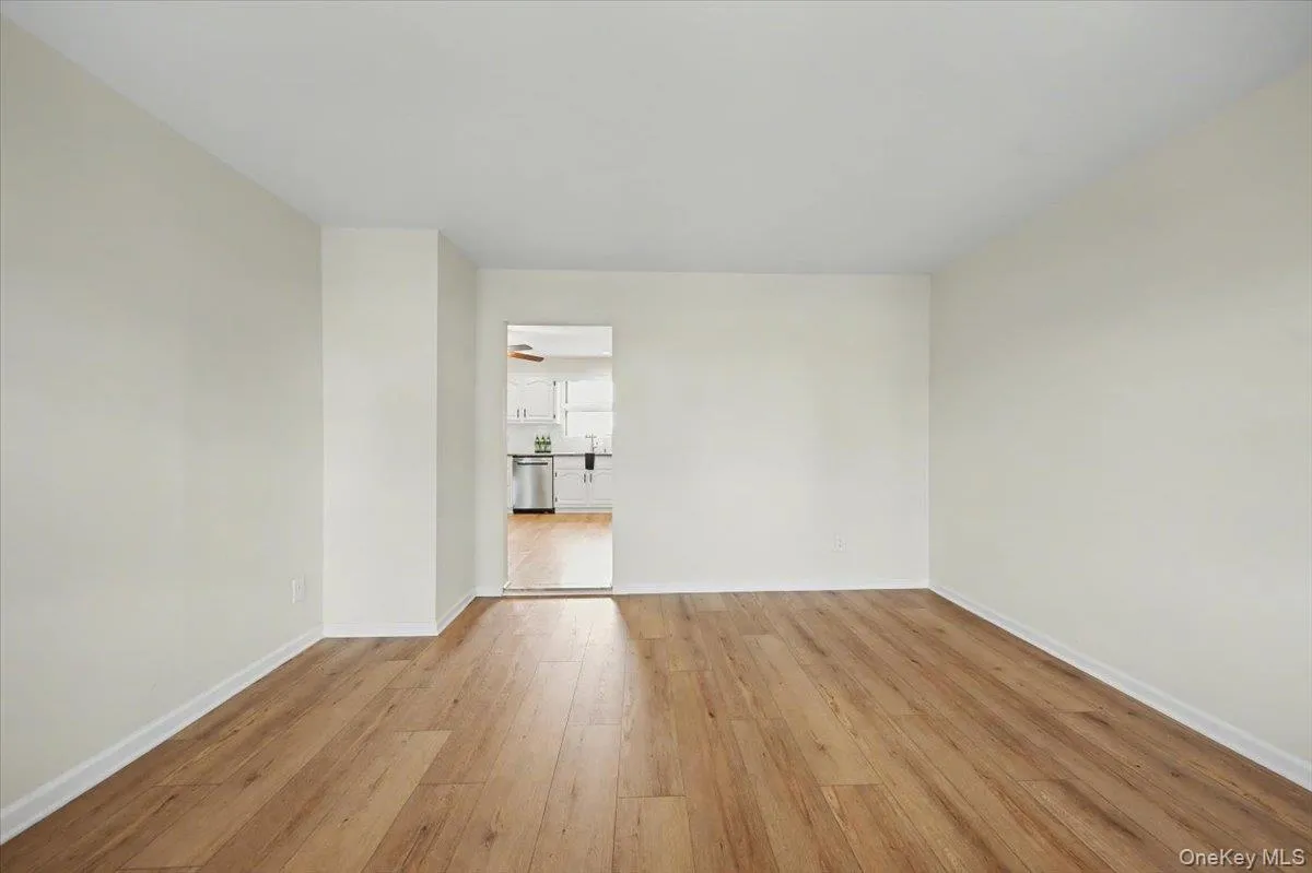 Empty room featuring light wood finished floors and baseboards Empty room featuring light wood finished floors and baseboards