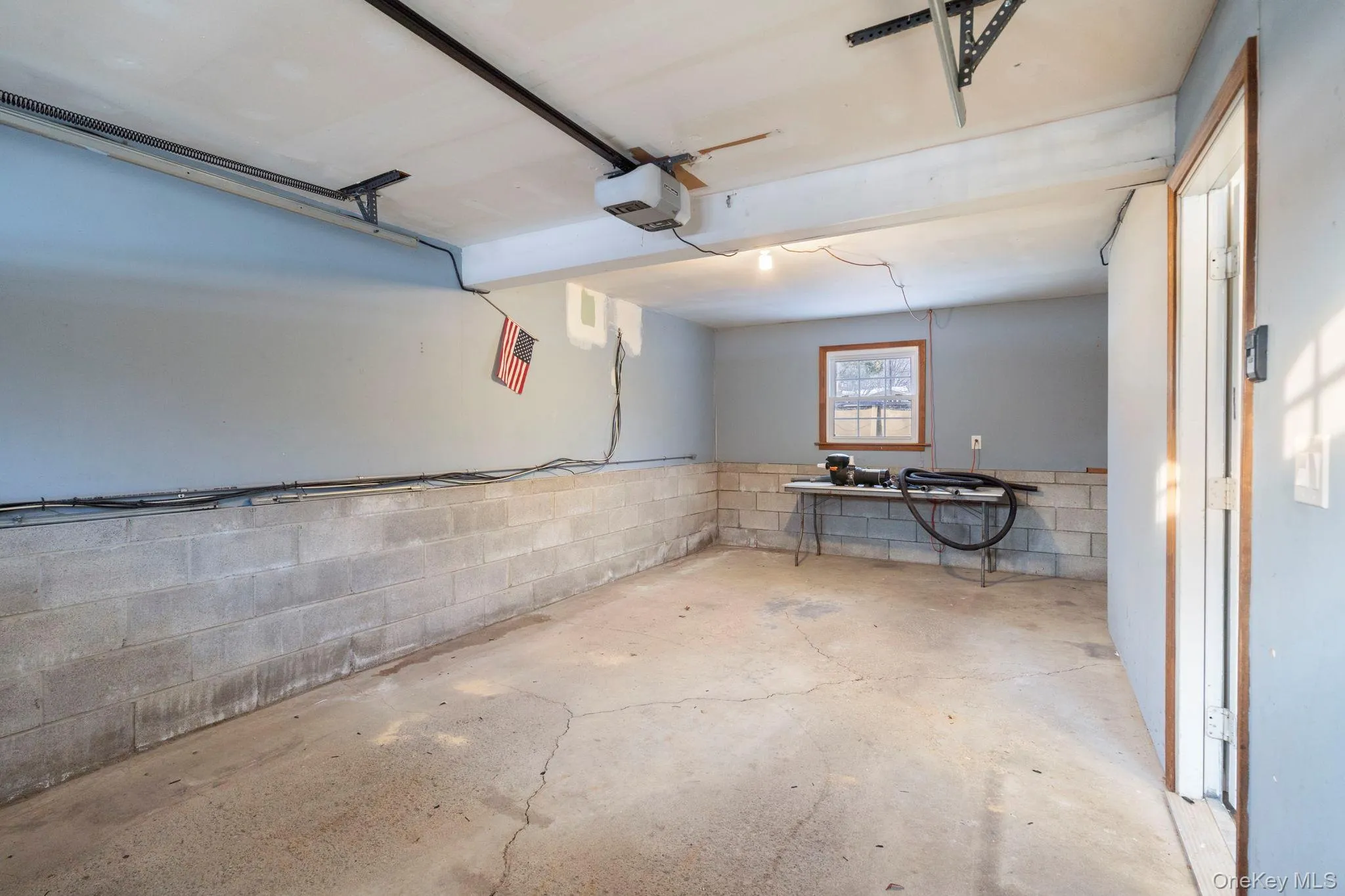 Garage with concrete block wall and a garage door opener Garage with concrete block wall and a garage door opener