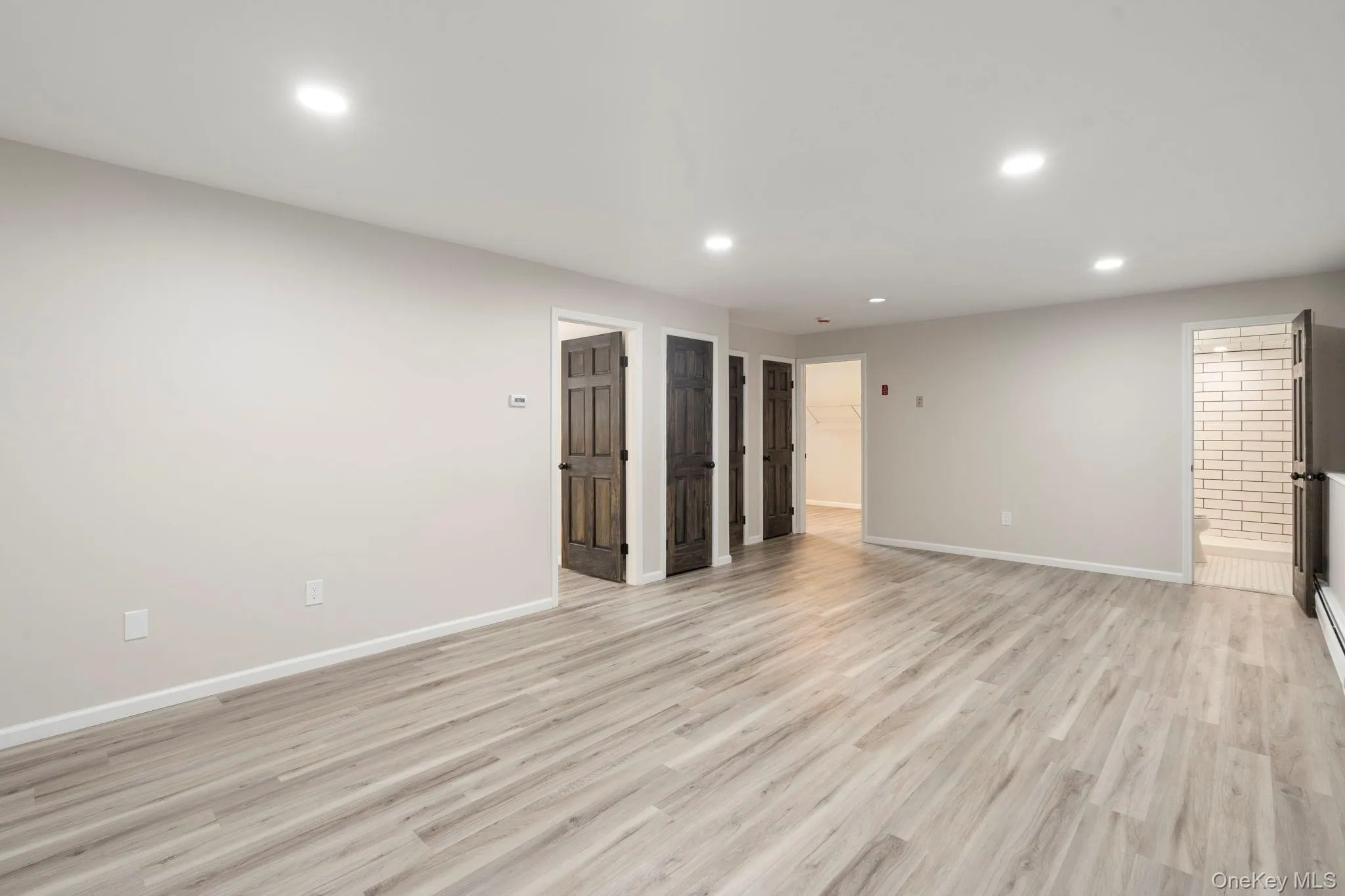 Unfurnished living room with recessed lighting and light wood-style floors Unfurnished living room with recessed lighting and light wood-style floors