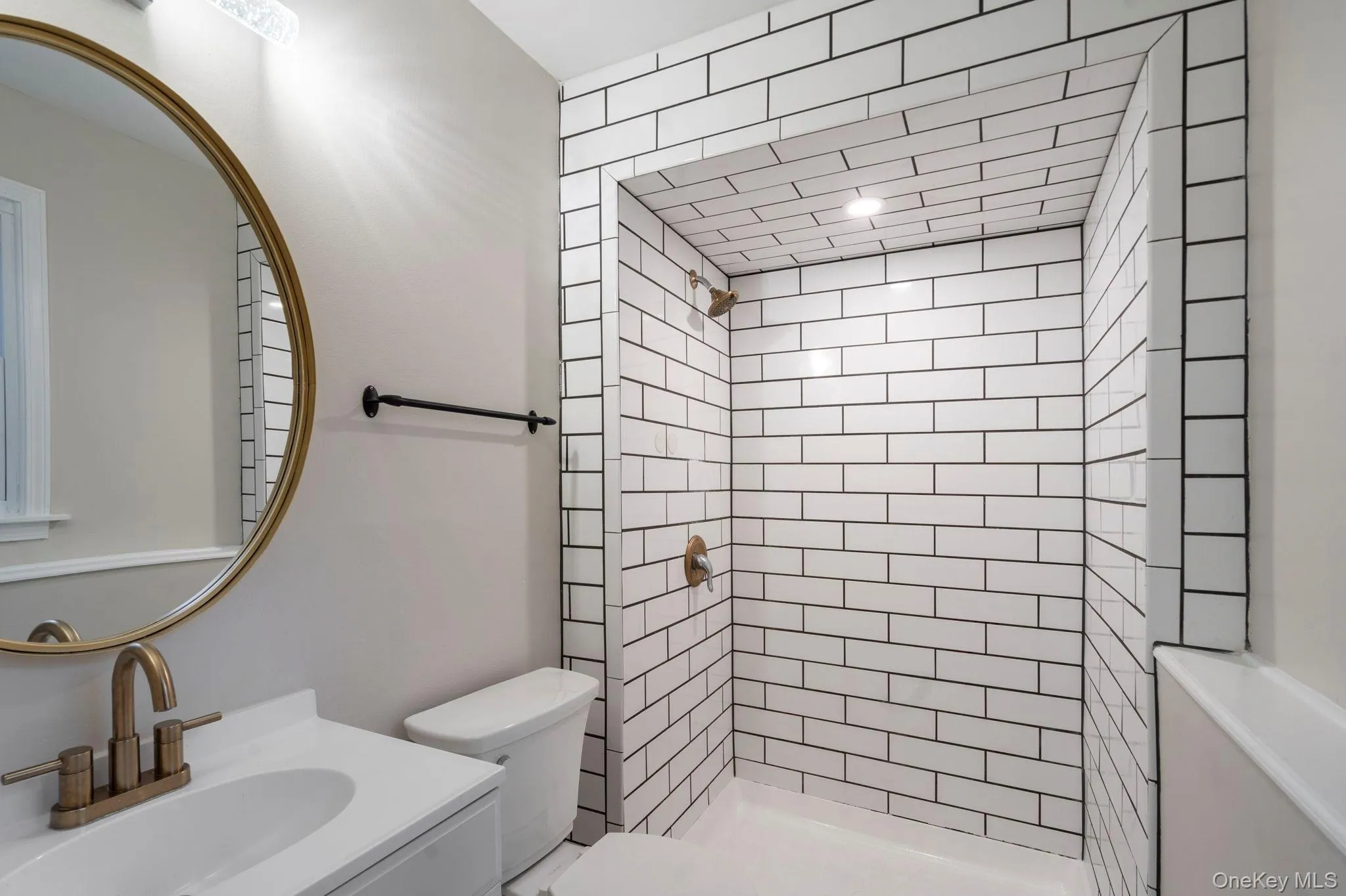 Bathroom featuring a stall shower and vanity Bathroom featuring a stall shower and vanity