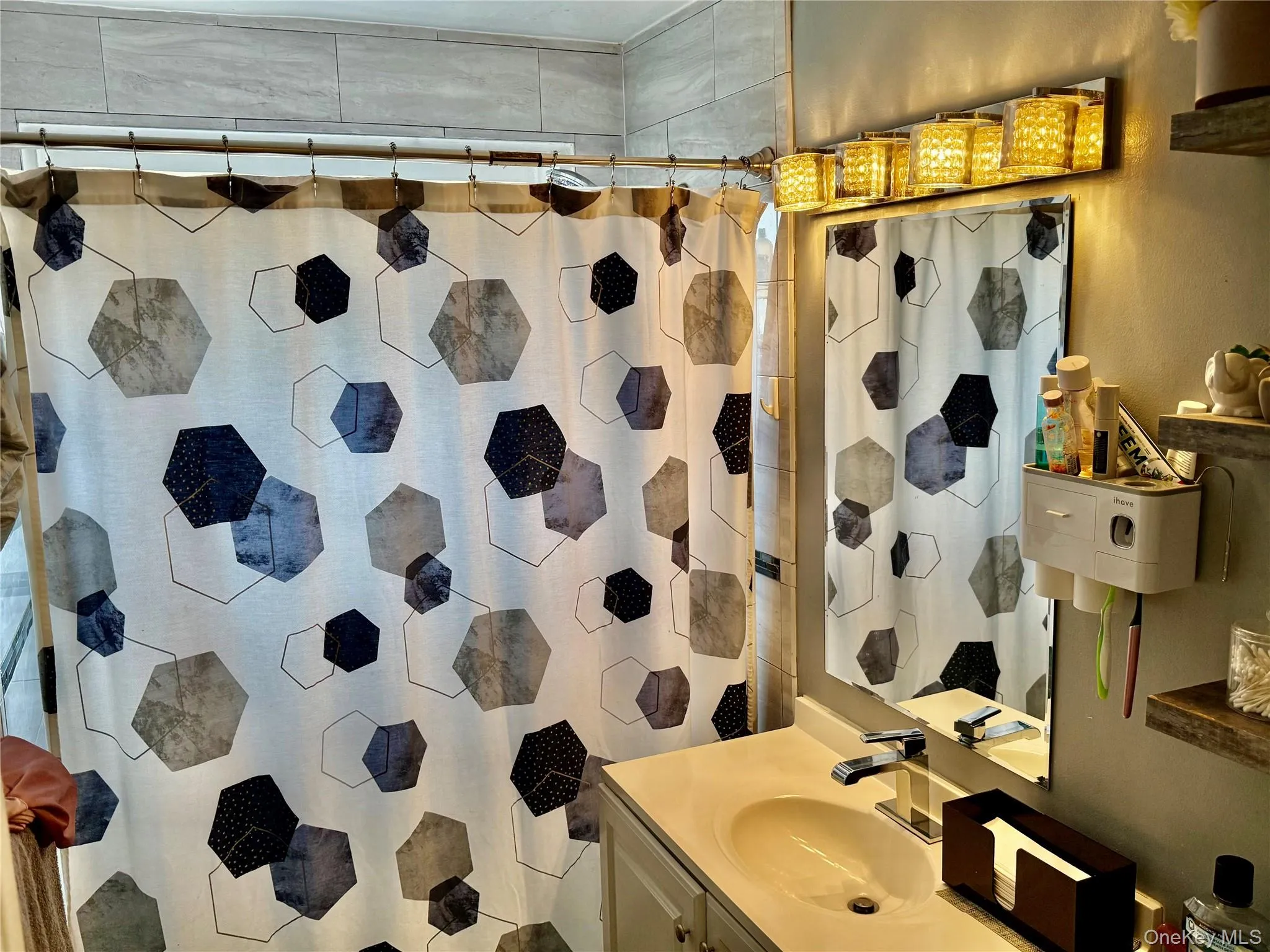 Bathroom with vanity and curtained shower Bathroom with vanity and curtained shower