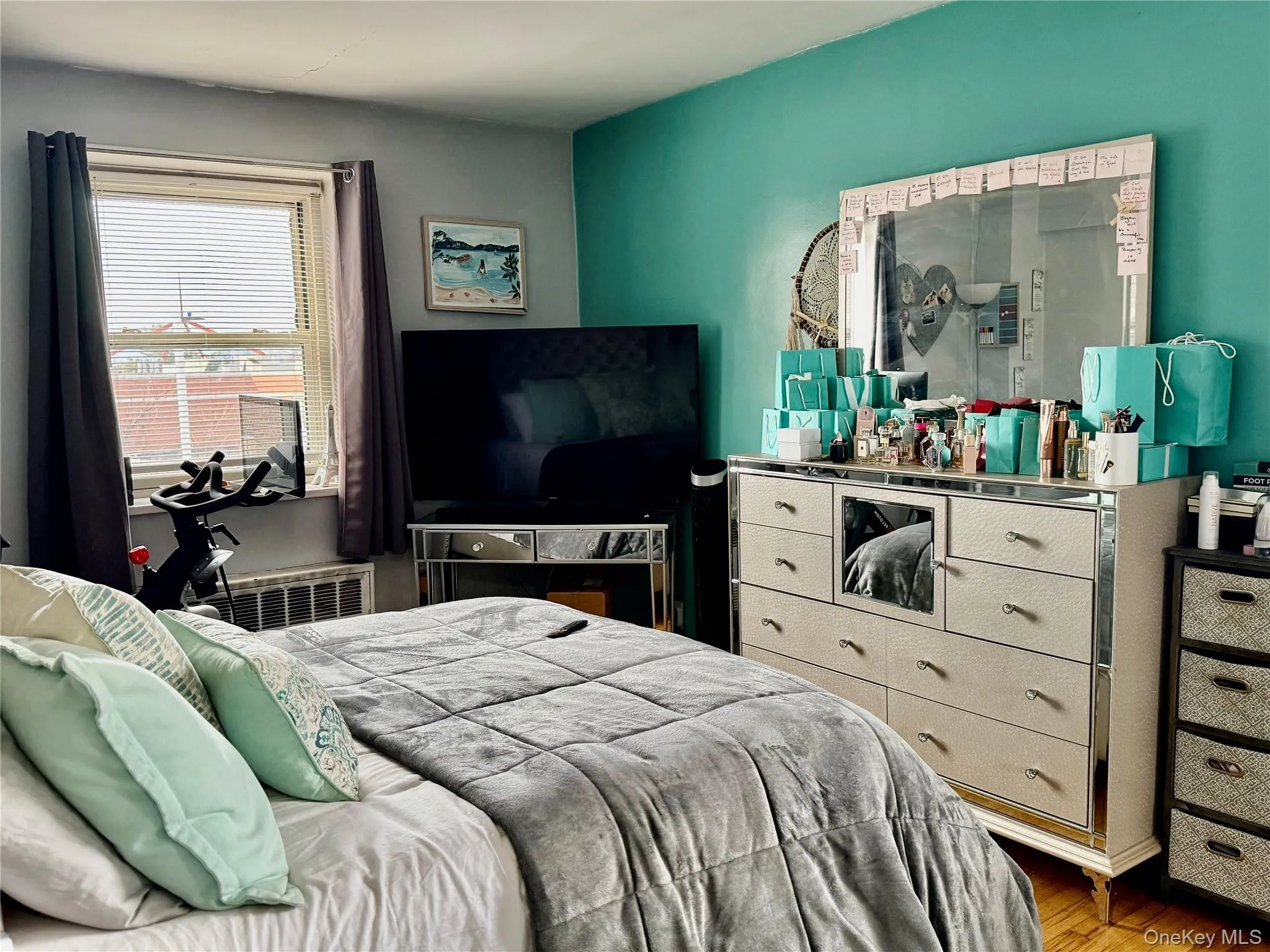 Bedroom with wood finished floors and radiator heating unit Bedroom with wood finished floors and radiator heating unit