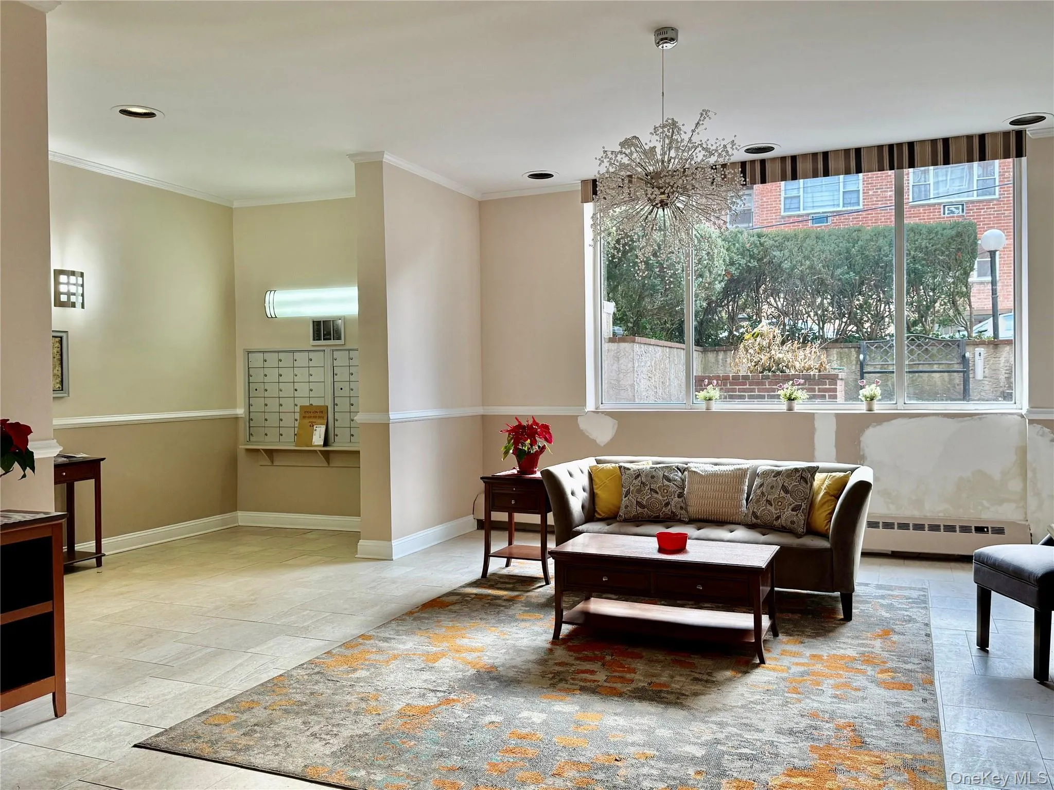 Living area with crown molding, a baseboard heating unit, stone tile flooring, and recessed lighting Living area with crown molding, a baseboard heating unit, stone tile flooring, and recessed lighting