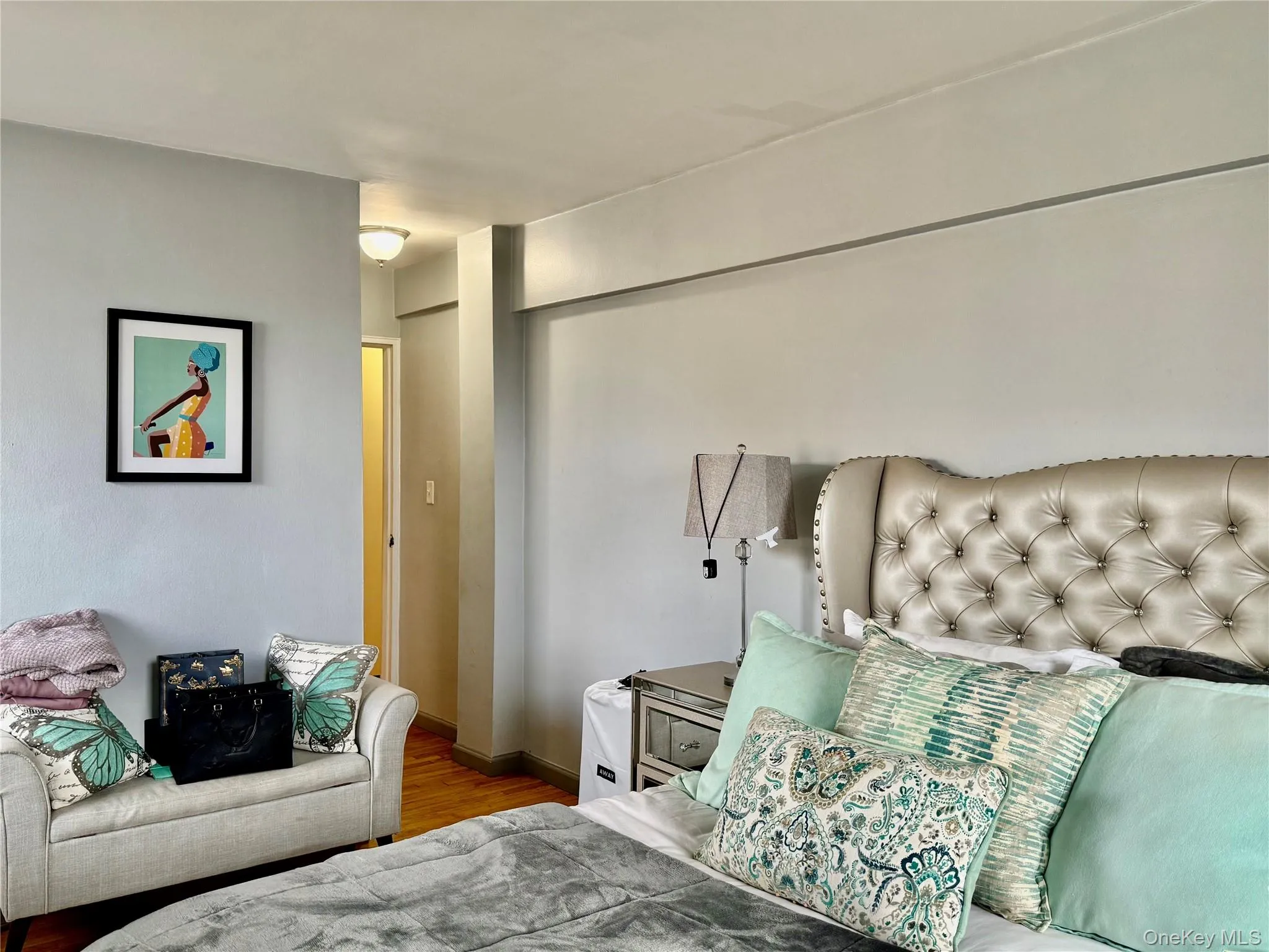 Bedroom featuring wood finished floors and baseboards Bedroom featuring wood finished floors and baseboards