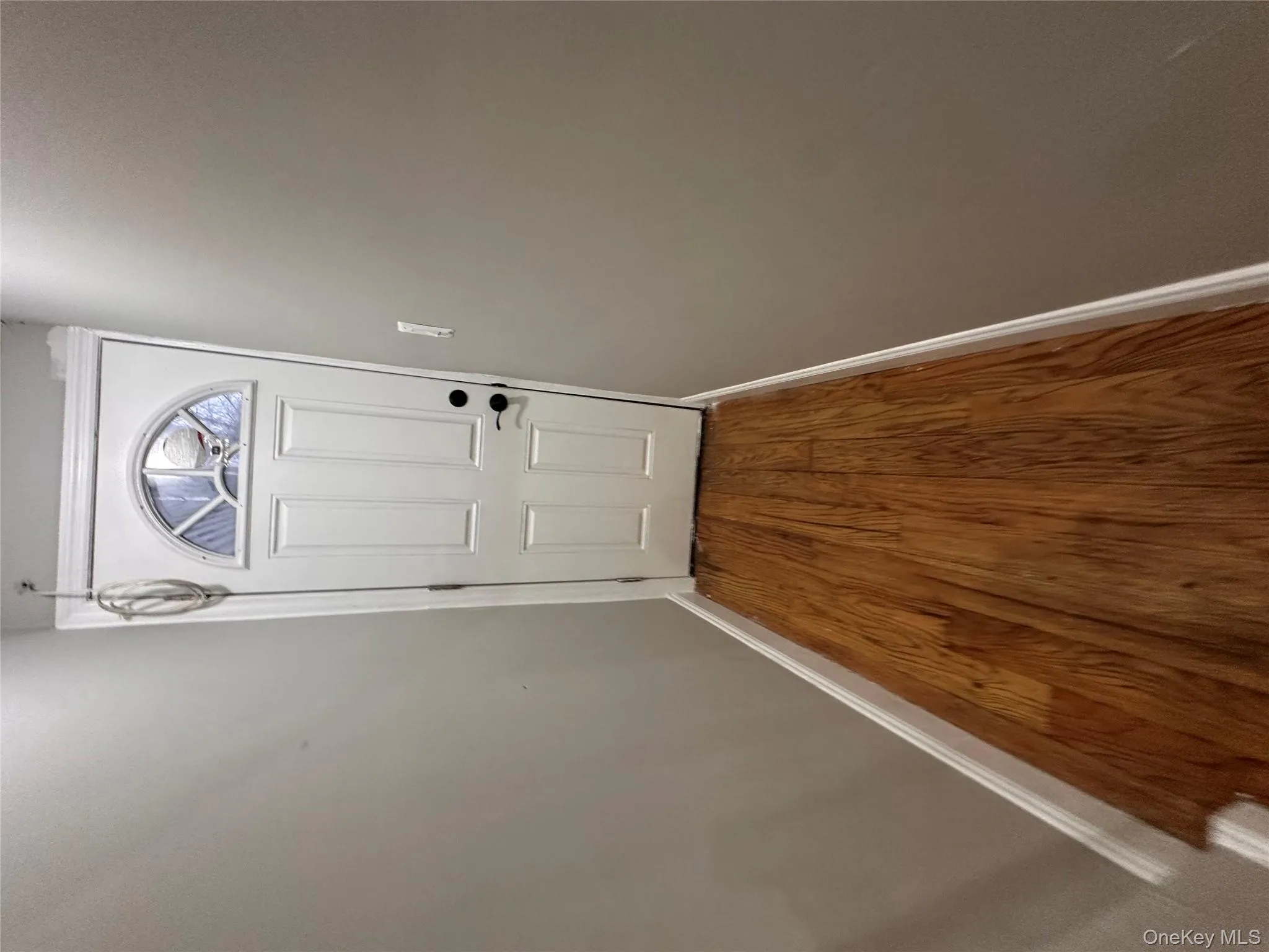 Entryway featuring baseboards and wood finished floors Entryway featuring baseboards and wood finished floors