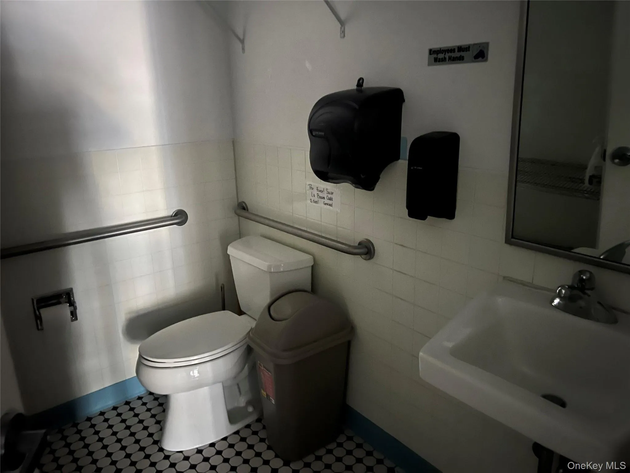 Half bath with toilet and tile walls Half bath with toilet and tile walls