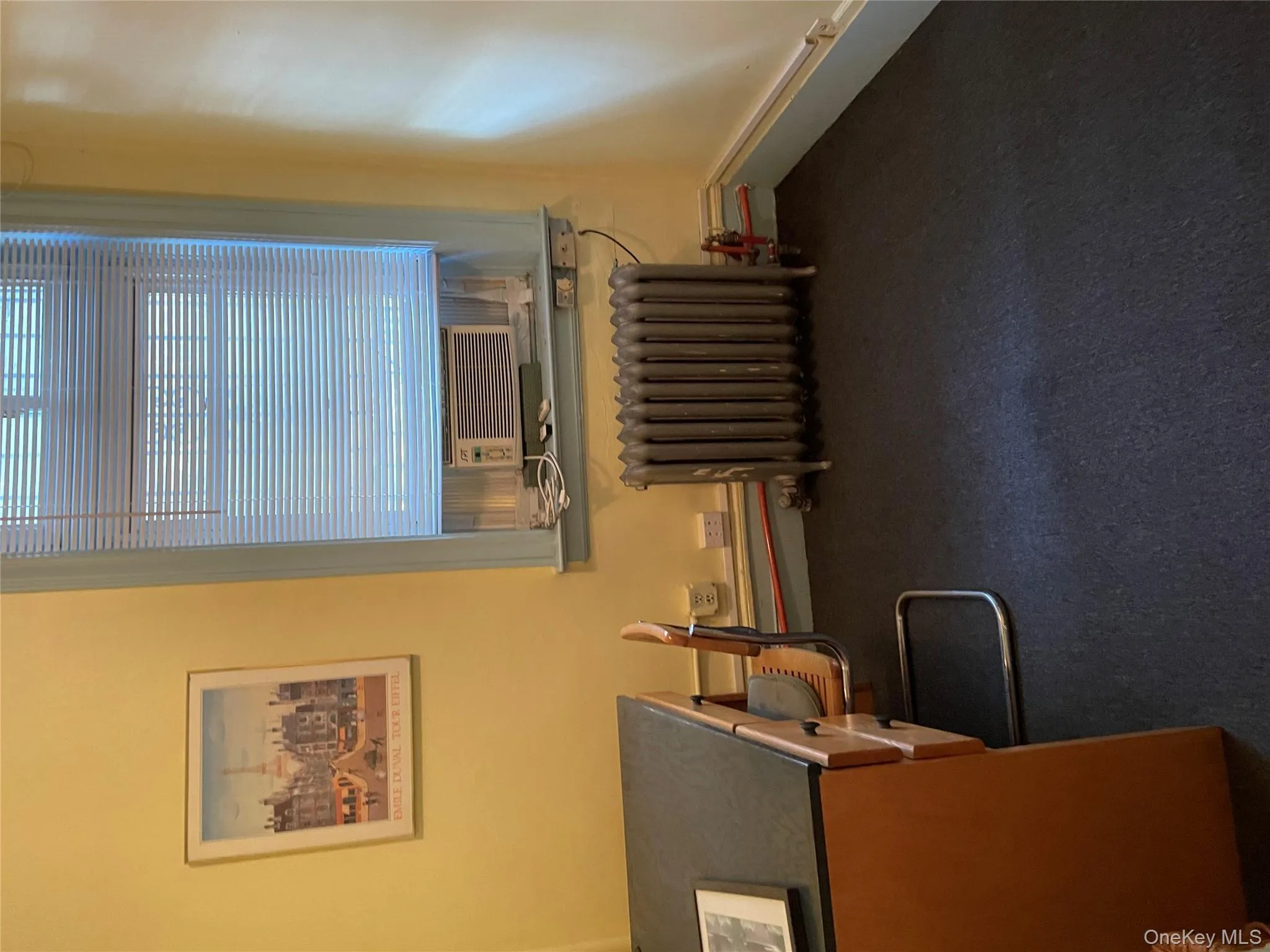 Office space featuring radiator and dark carpet Office space featuring radiator and dark carpet