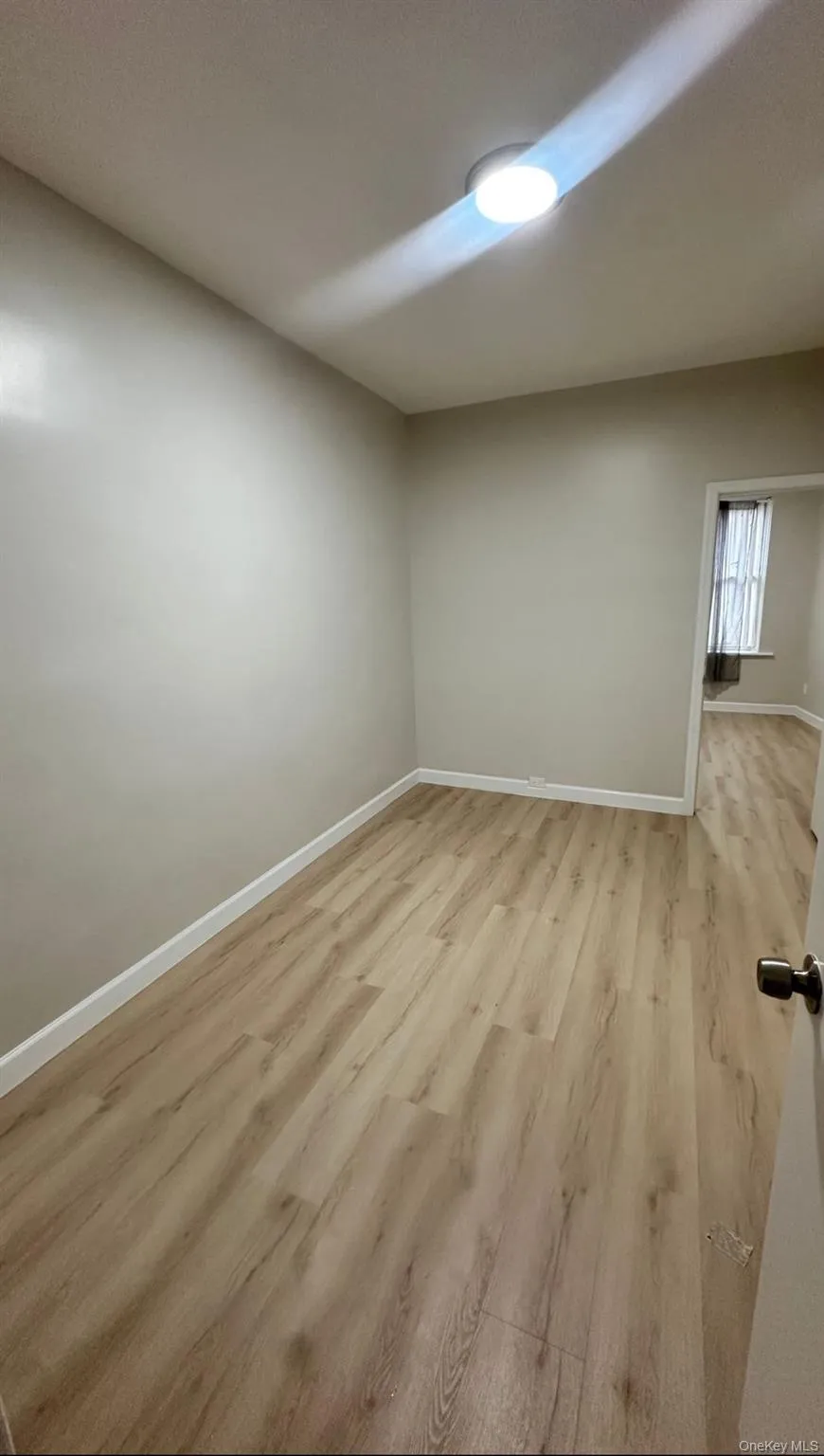 Spare room featuring baseboards and light wood-style floors Spare room featuring baseboards and light wood-style floors
