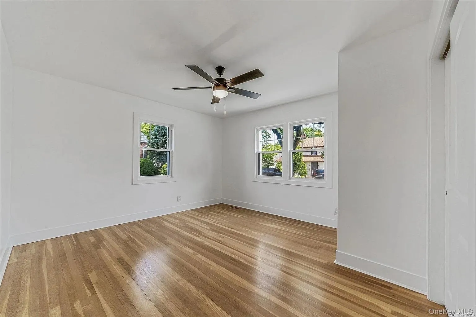 Unfurnished room featuring light wood-style flooring and a ceiling fan Unfurnished room featuring light wood-style flooring and a ceiling fan
