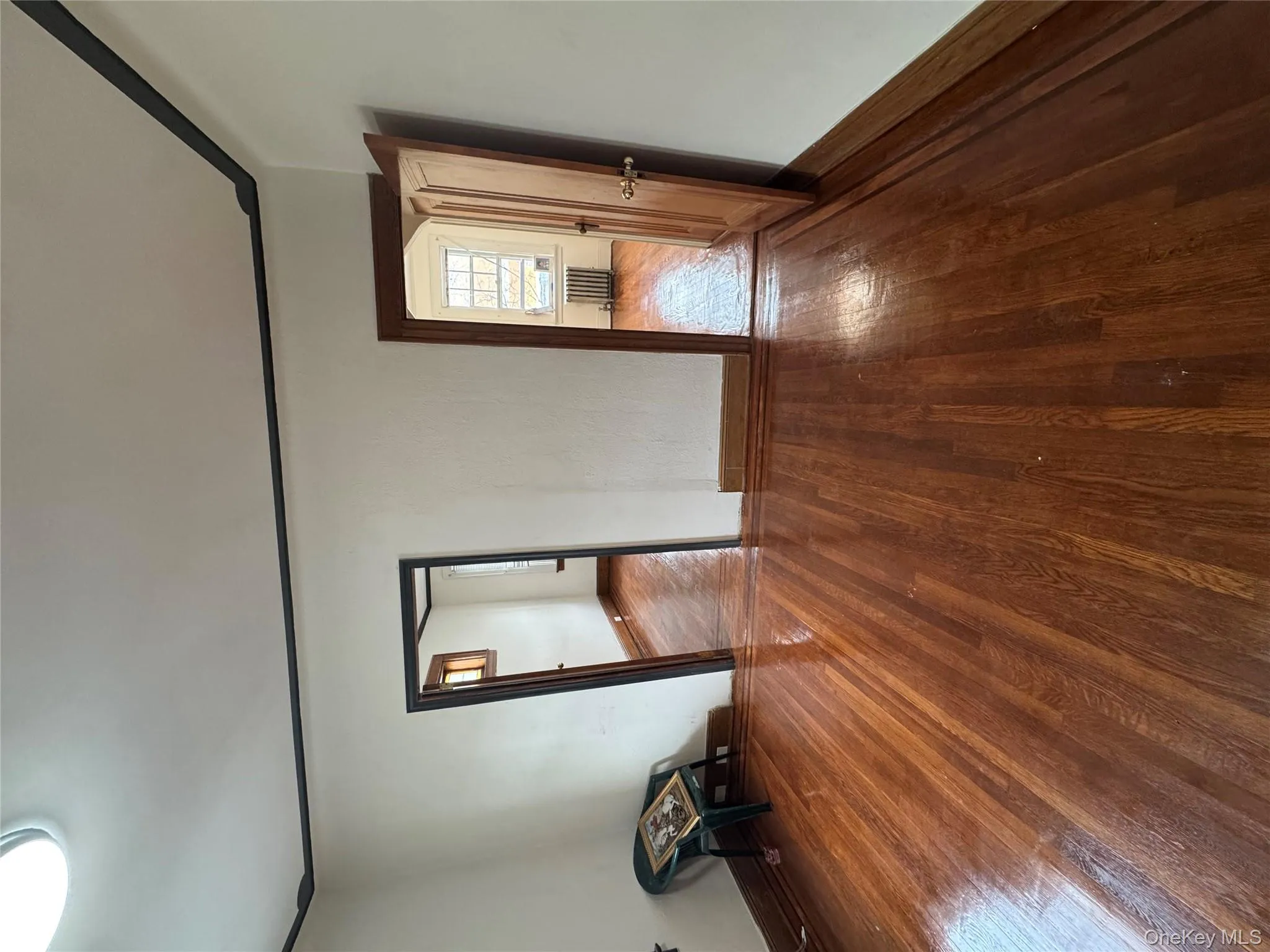 Spare room featuring hardwood / wood-style flooring, radiator, and crown molding Spare room featuring hardwood / wood-style flooring, radiator, and crown molding