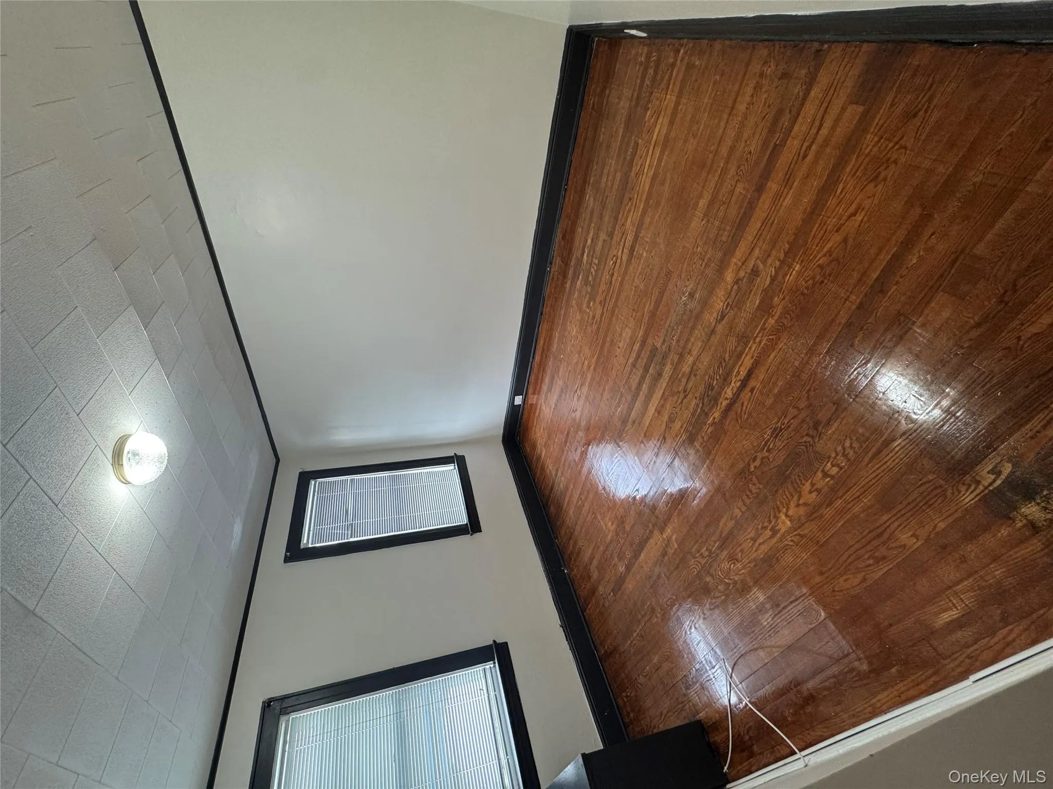 Unfurnished room featuring baseboards and hardwood / wood-style flooring Unfurnished room featuring baseboards and hardwood / wood-style flooring