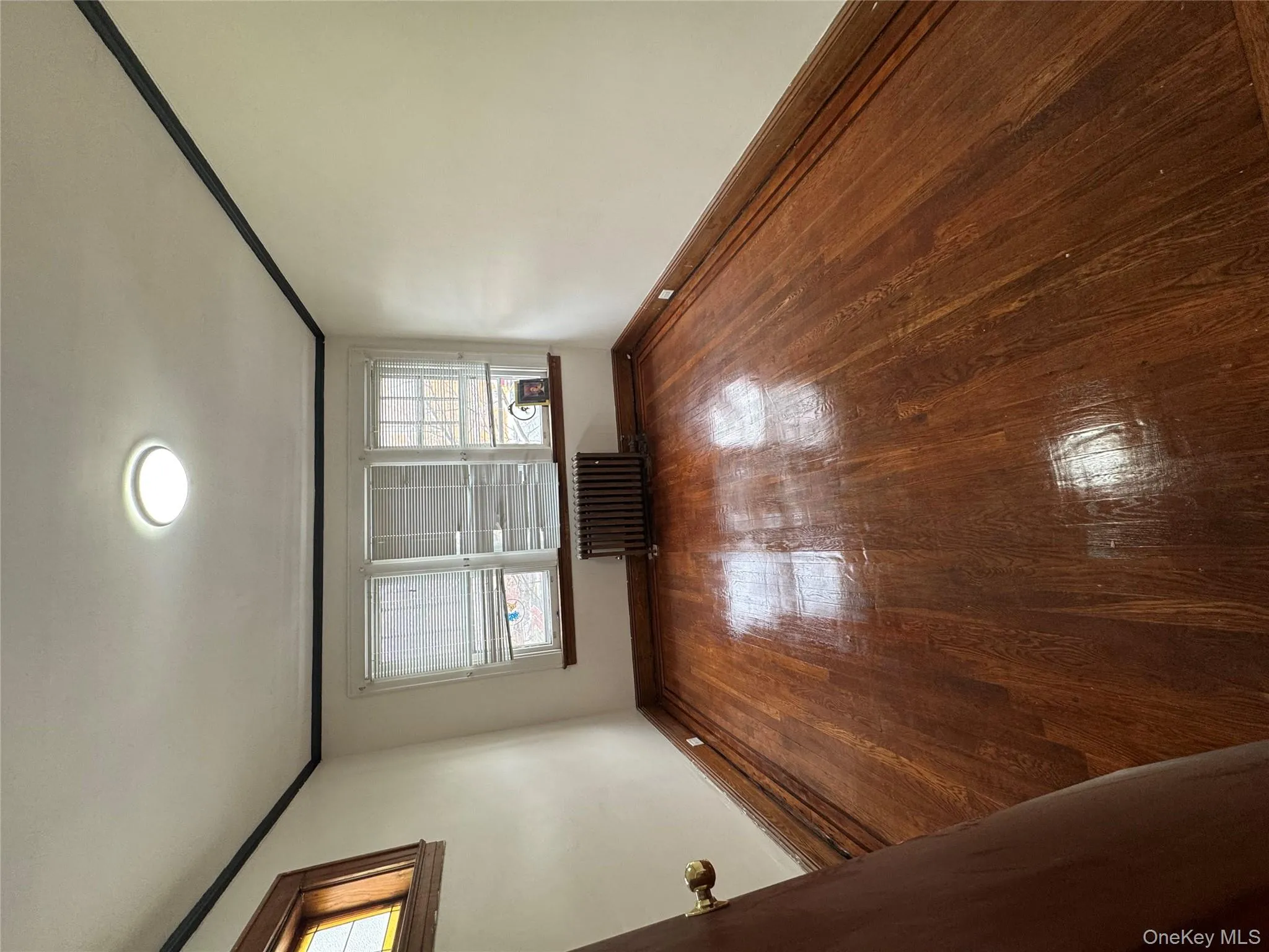 Spare room with radiator, ornamental molding, and hardwood / wood-style floors Spare room with radiator, ornamental molding, and hardwood / wood-style floors