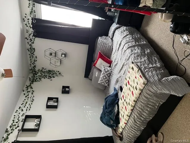 Bedroom with a ceiling fan and carpet Bedroom with a ceiling fan and carpet