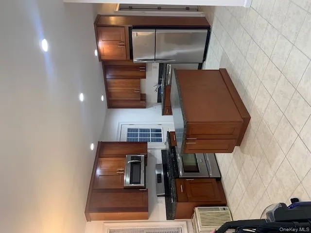 Kitchen with range, refrigerator, a kitchen island, dishwasher, and recessed lighting Kitchen with range, refrigerator, a kitchen island, dishwasher, and recessed lighting
