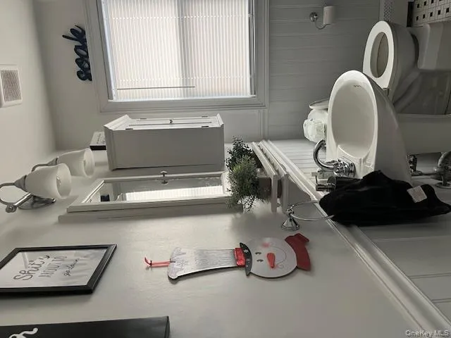 Half bath with wainscoting and a decorative wall Half bath with wainscoting and a decorative wall