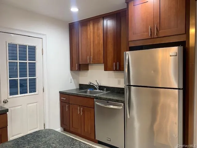Kitchen featuring stainless steel appliances, brown cabinets, and recessed lighting Kitchen featuring stainless steel appliances, brown cabinets, and recessed lighting