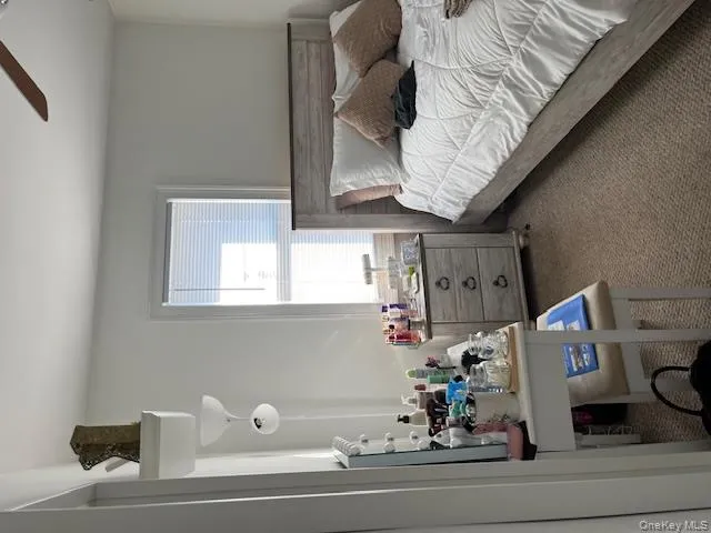 Carpeted bedroom featuring ceiling fan Carpeted bedroom featuring ceiling fan