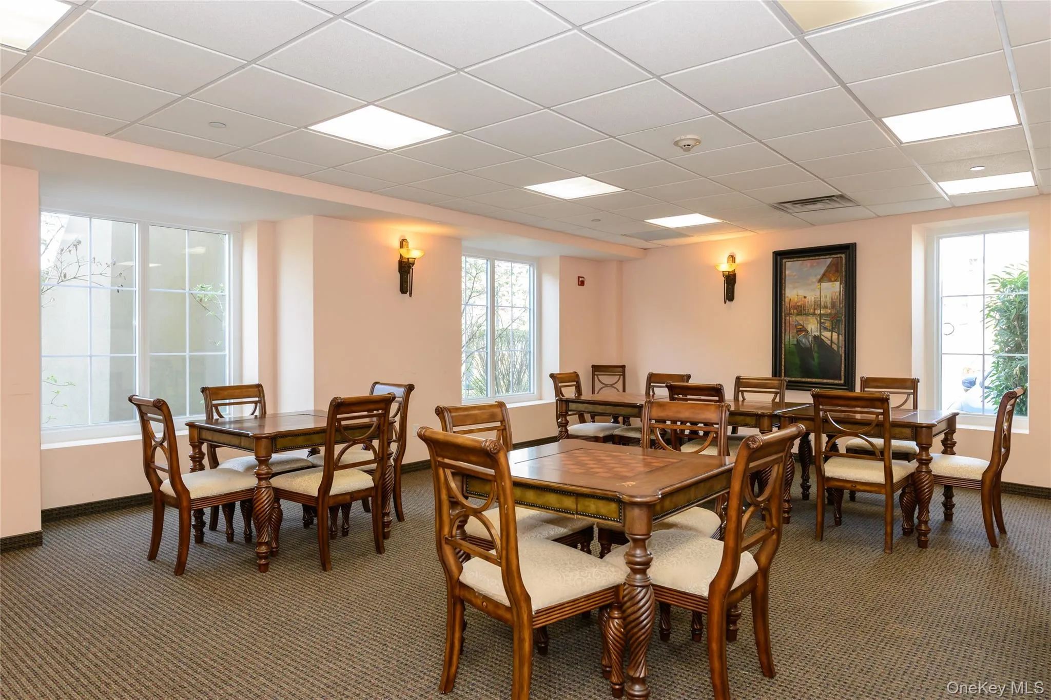 Dining area featuring a drop ceiling and carpet flooring Dining area featuring a drop ceiling and carpet flooring