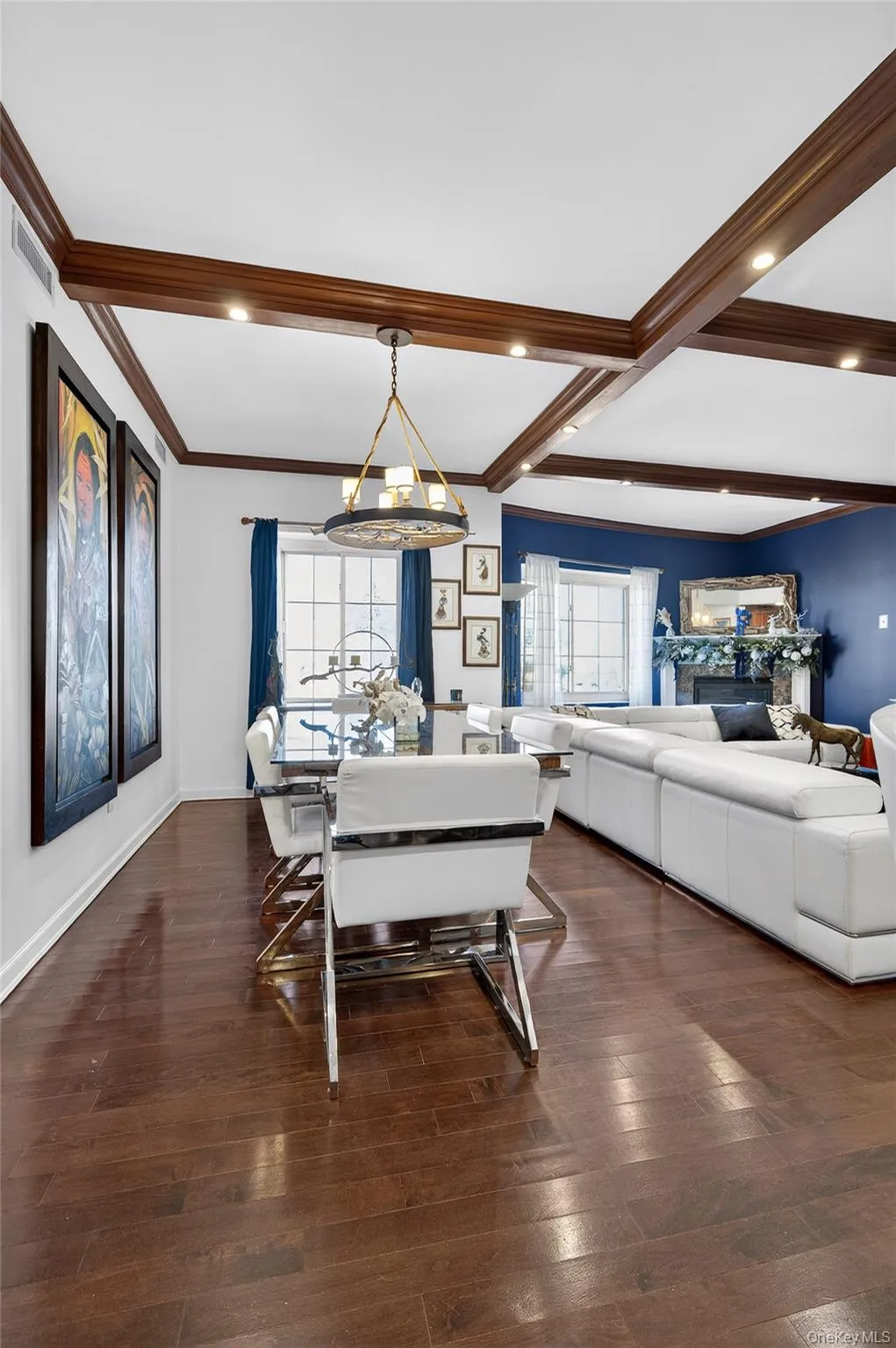 Dining space featuring a chandelier, dark wood finished floors, a fireplace, crown molding, and recessed lighting Dining space featuring a chandelier, dark wood finished floors, a fireplace, crown molding, and recessed lighting