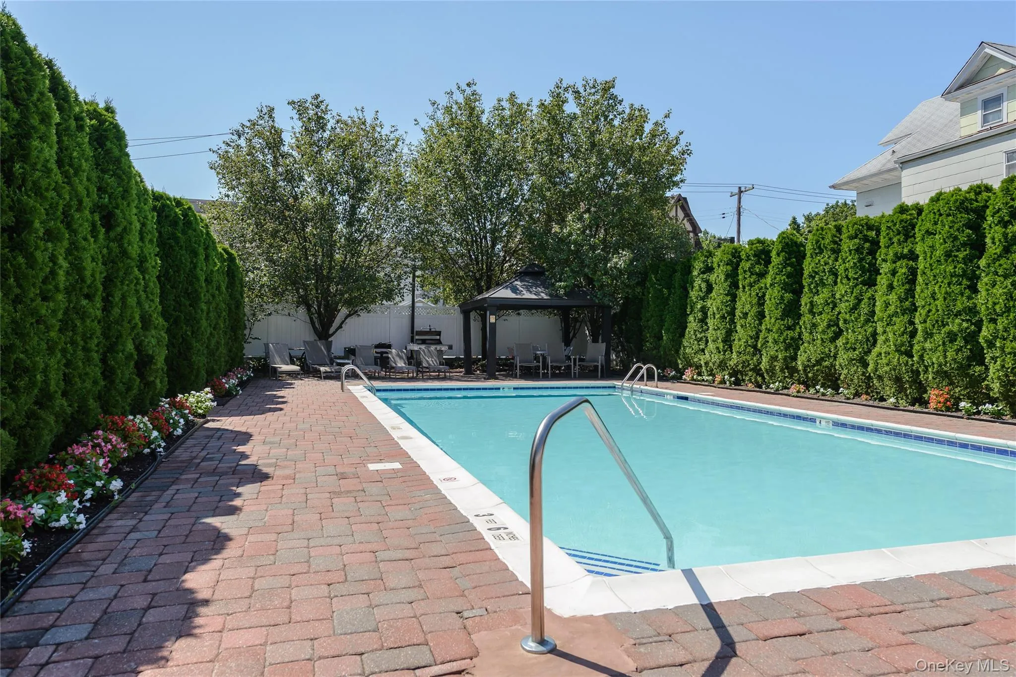 Community pool featuring a gazebo, a patio, and a fenced backyard Community pool featuring a gazebo, a patio, and a fenced backyard