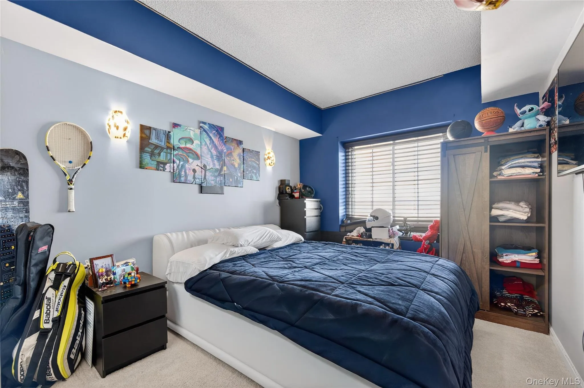 Bedroom with a textured ceiling and carpet flooring Bedroom with a textured ceiling and carpet flooring