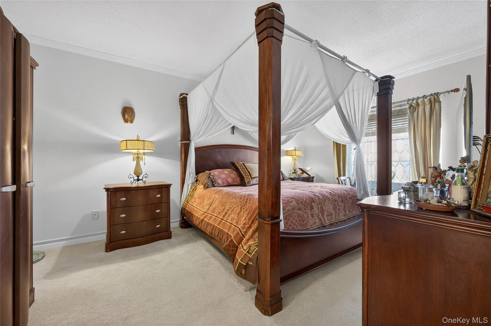 Carpeted bedroom featuring crown molding and a textured ceiling Carpeted bedroom featuring crown molding and a textured ceiling