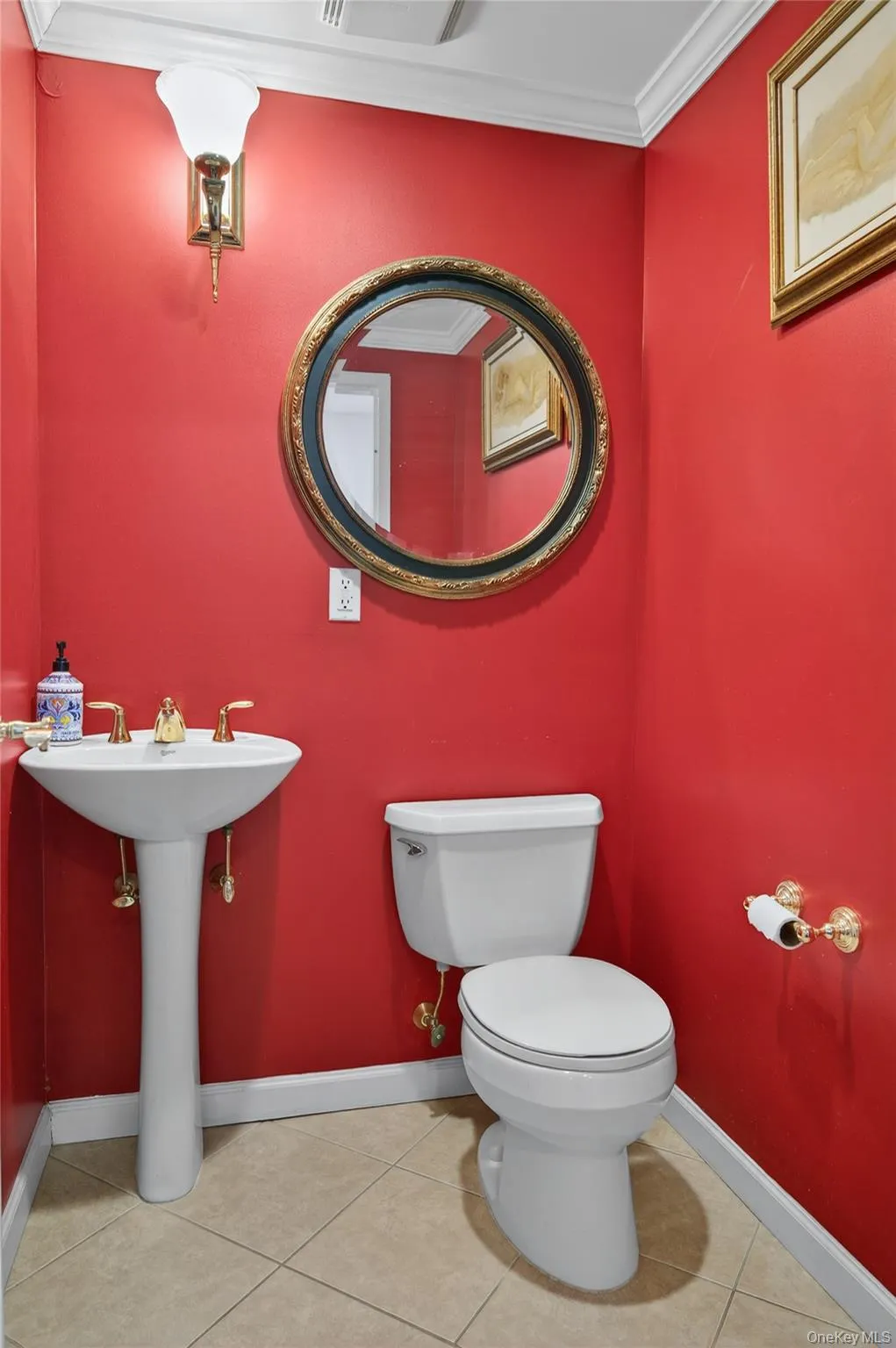 Bathroom with crown molding and light tile patterned floors Bathroom with crown molding and light tile patterned floors