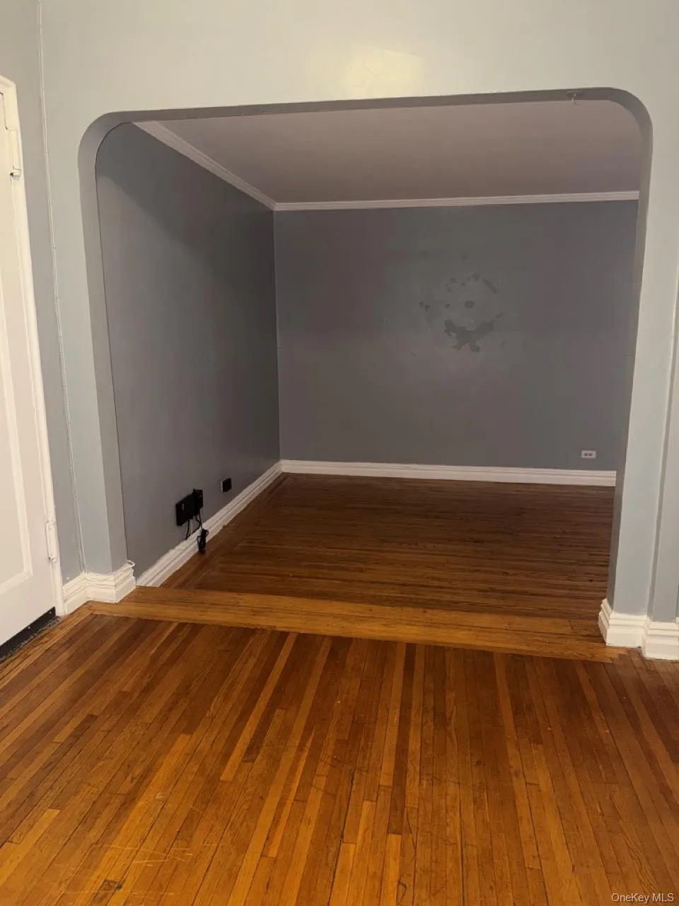 Entry Foyer with arched walkways, crown molding, and hardwood floors Entry Foyer with arched walkways, crown molding, and hardwood floors