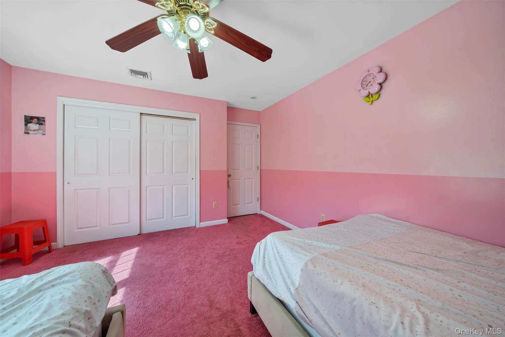 Bedroom with a closet, ceiling fan, and carpet flooring Bedroom with a closet, ceiling fan, and carpet flooring
