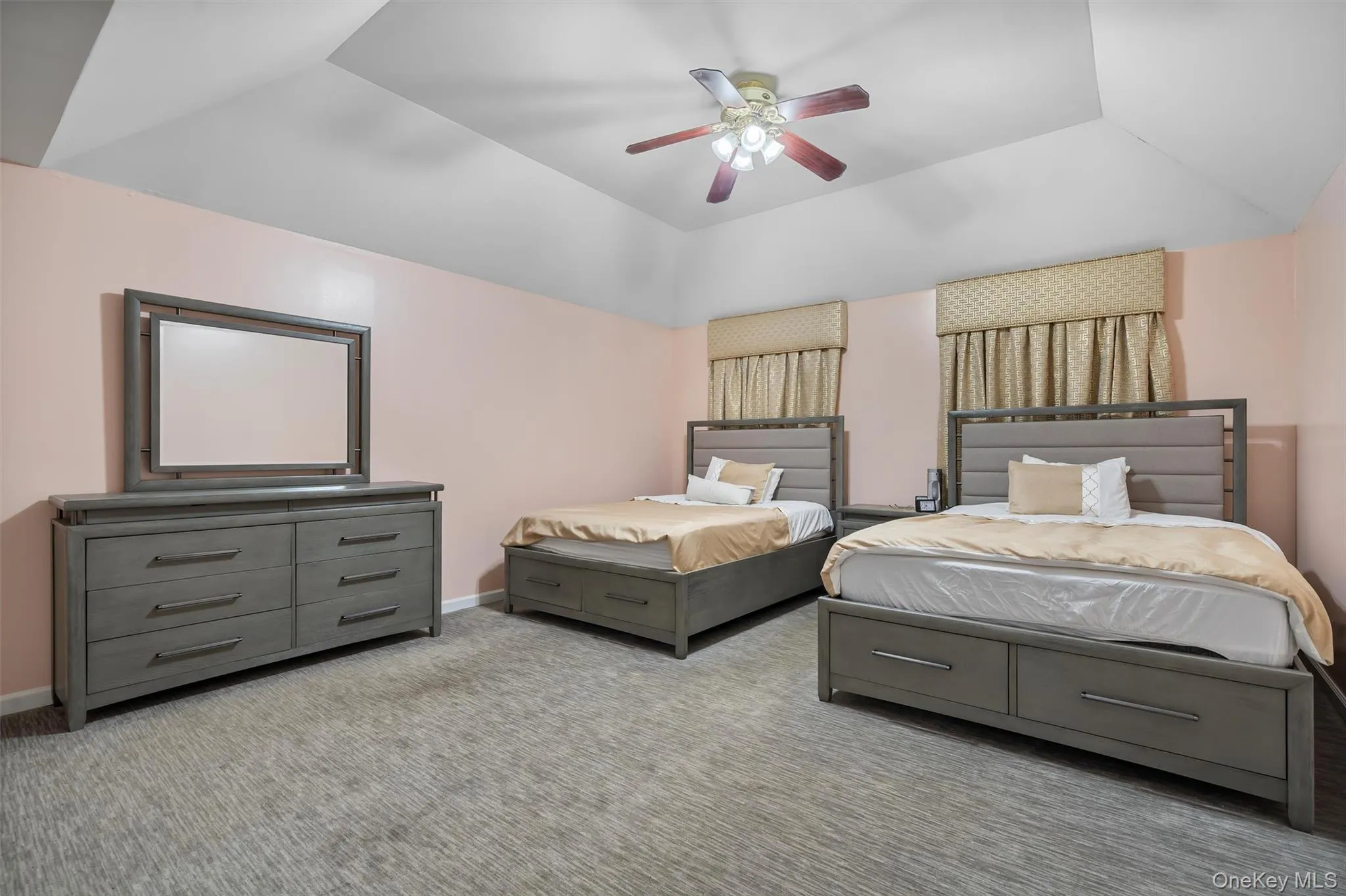Bedroom with light colored carpet, a ceiling fan, and lofted ceiling Bedroom with light colored carpet, a ceiling fan, and lofted ceiling