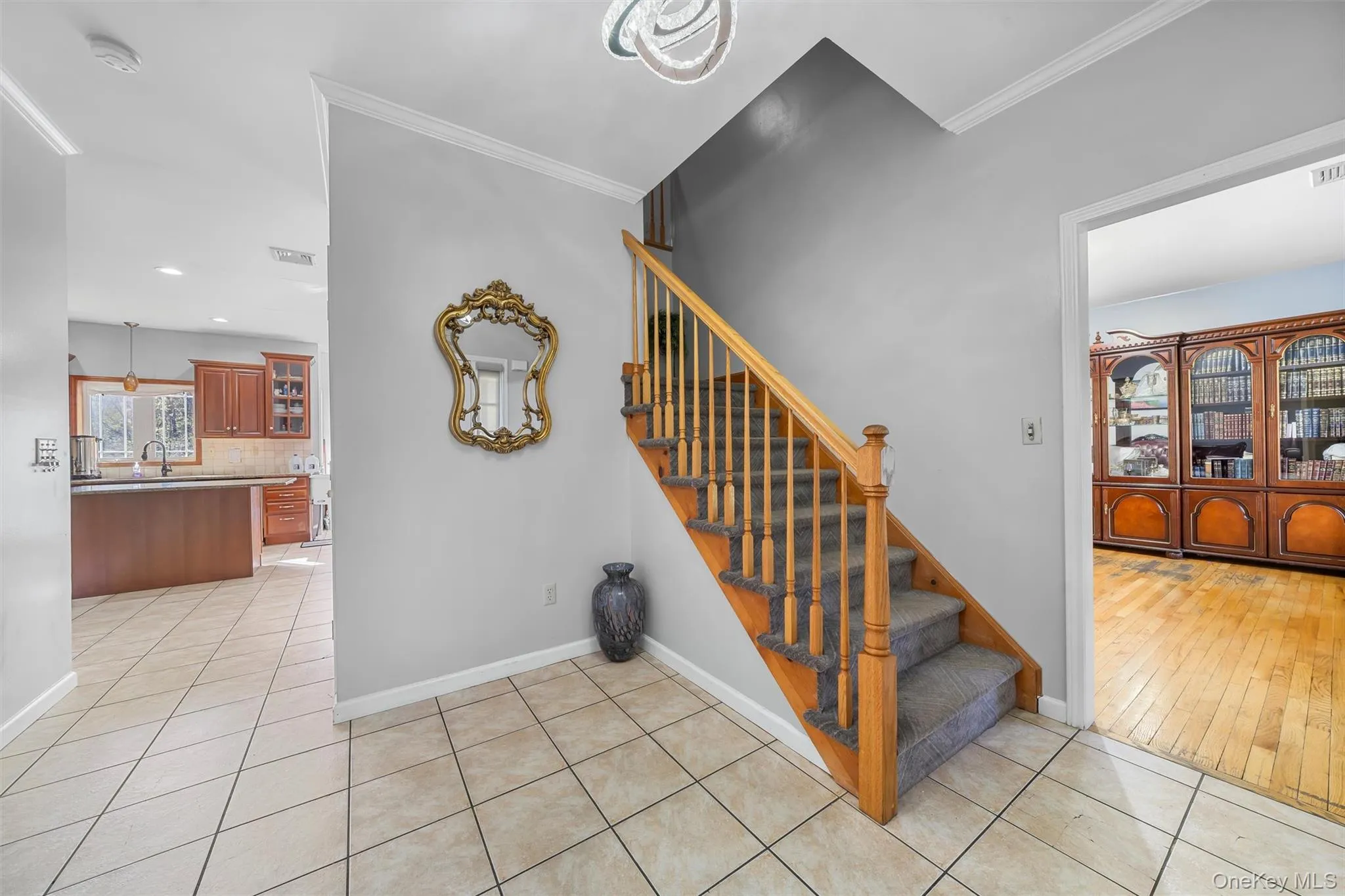 Staircase with ornamental molding, tile patterned floors, and recessed lighting Staircase with ornamental molding, tile patterned floors, and recessed lighting