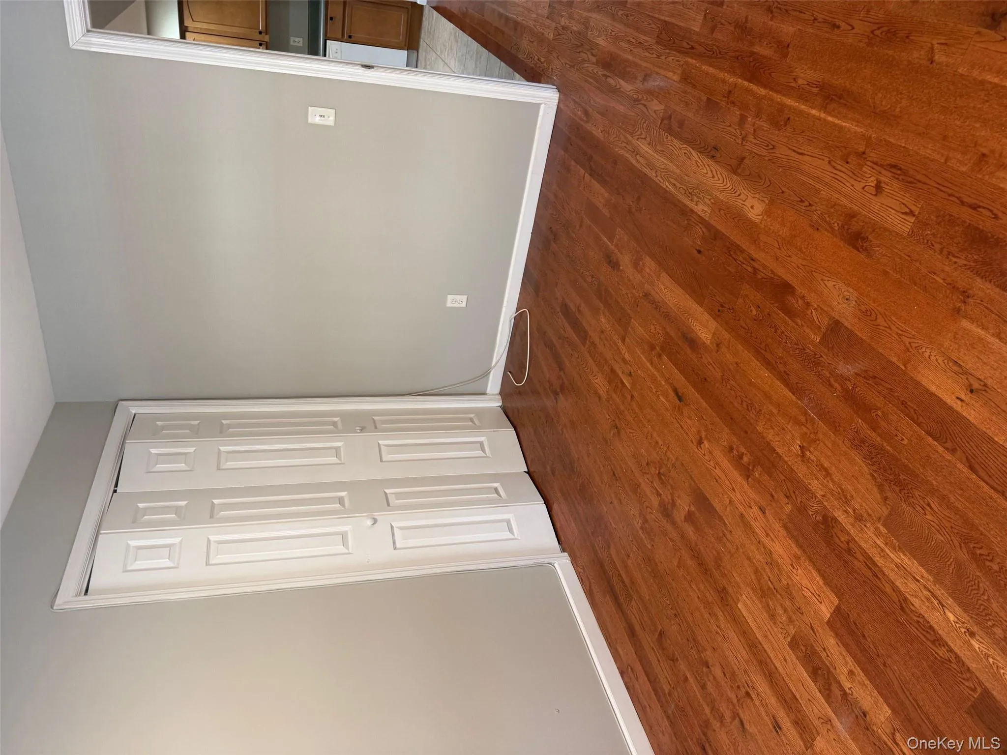 Unfurnished bedroom featuring dark wood finished floors and a closet Unfurnished bedroom featuring dark wood finished floors and a closet