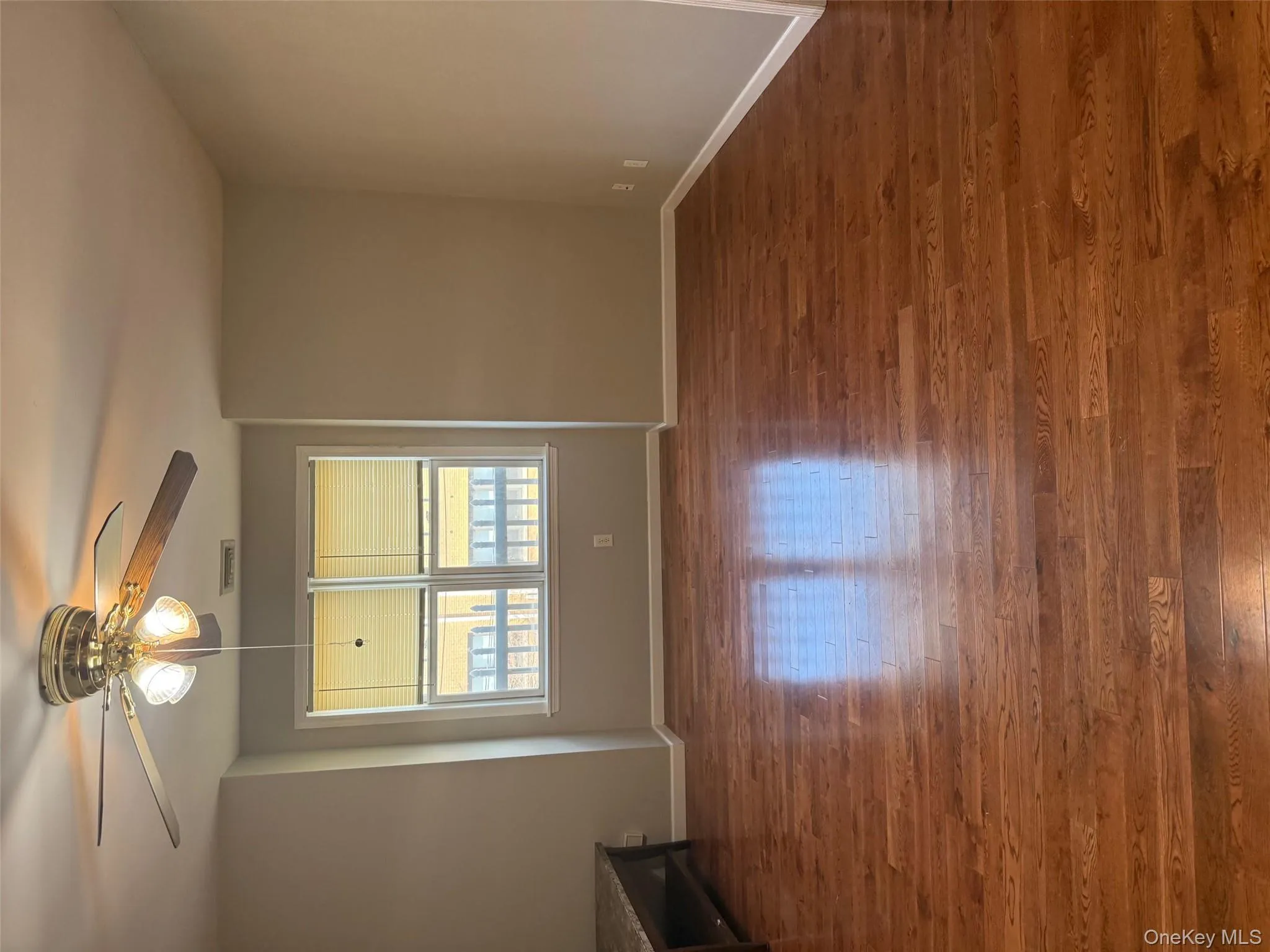 Unfurnished room with dark wood-type flooring and ceiling fan Unfurnished room with dark wood-type flooring and ceiling fan