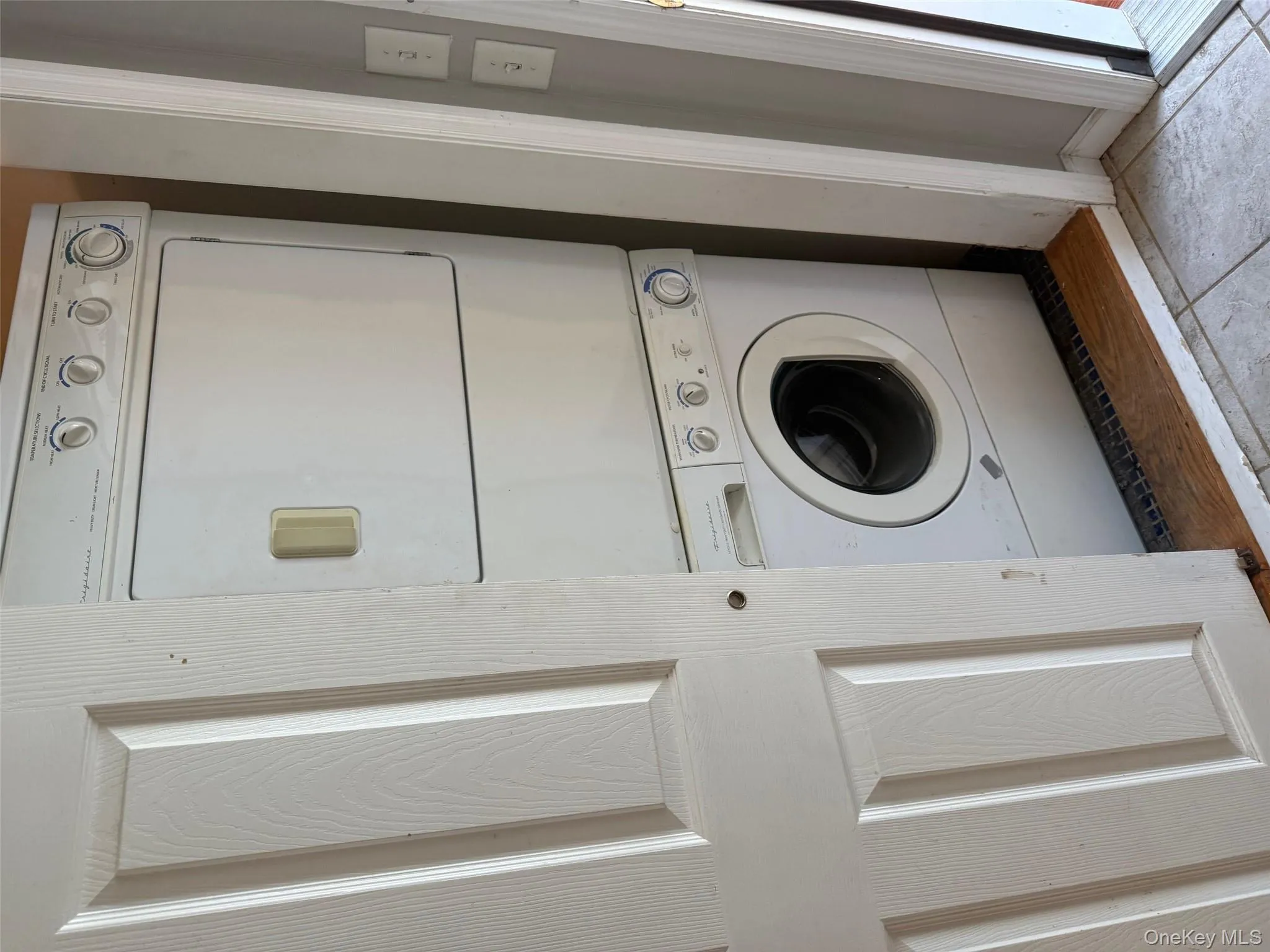 Laundry area featuring stacked washer / dryer Laundry area featuring stacked washer / dryer