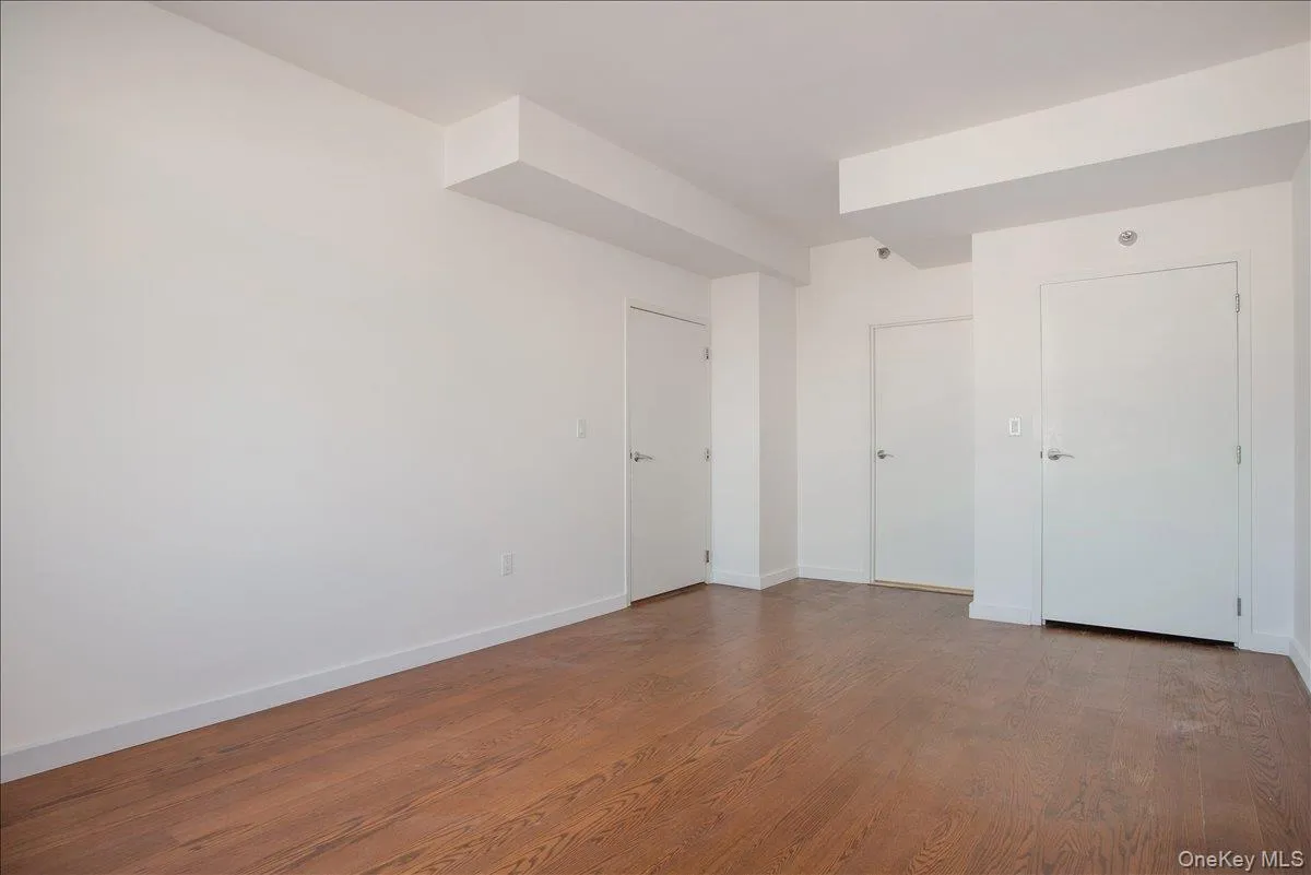 Unfurnished bedroom featuring baseboards and wood finished floors Unfurnished bedroom featuring baseboards and wood finished floors