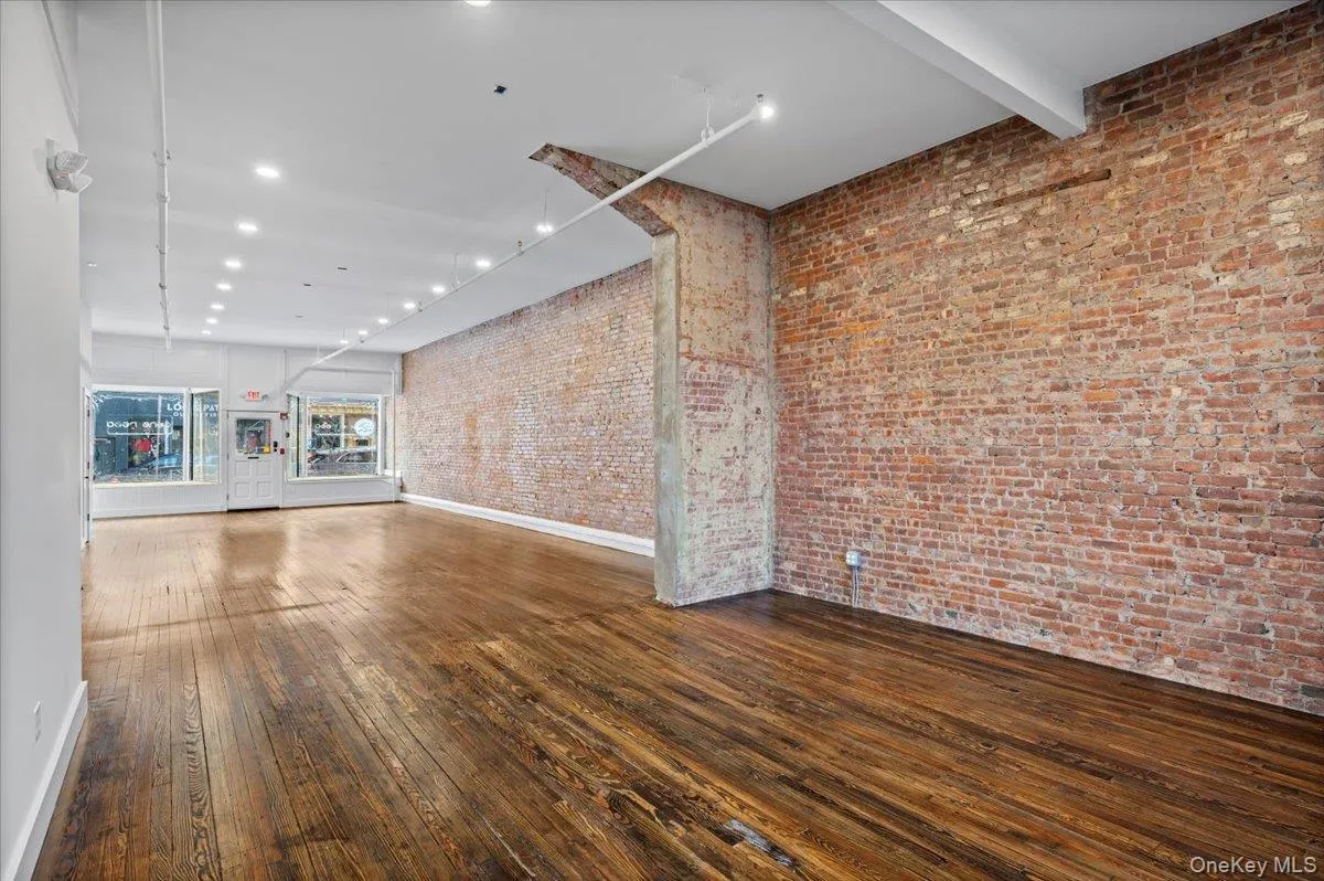 Unfurnished living room with dark wood-type flooring and recessed lighting Unfurnished living room with dark wood-type flooring and recessed lighting