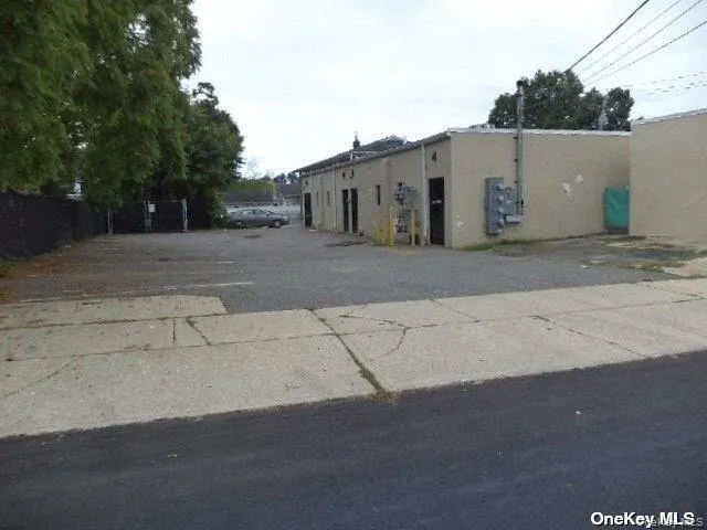 View of building exterior featuring uncovered parking View of building exterior featuring uncovered parking