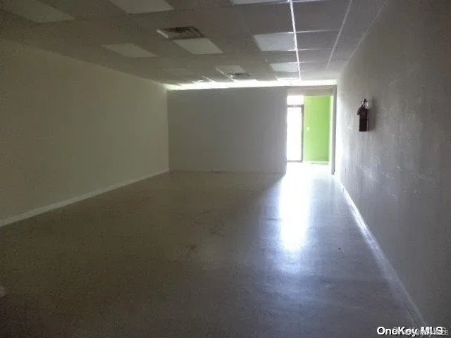 Unfurnished room featuring a paneled ceiling and tile patterned floors Unfurnished room featuring a paneled ceiling and tile patterned floors