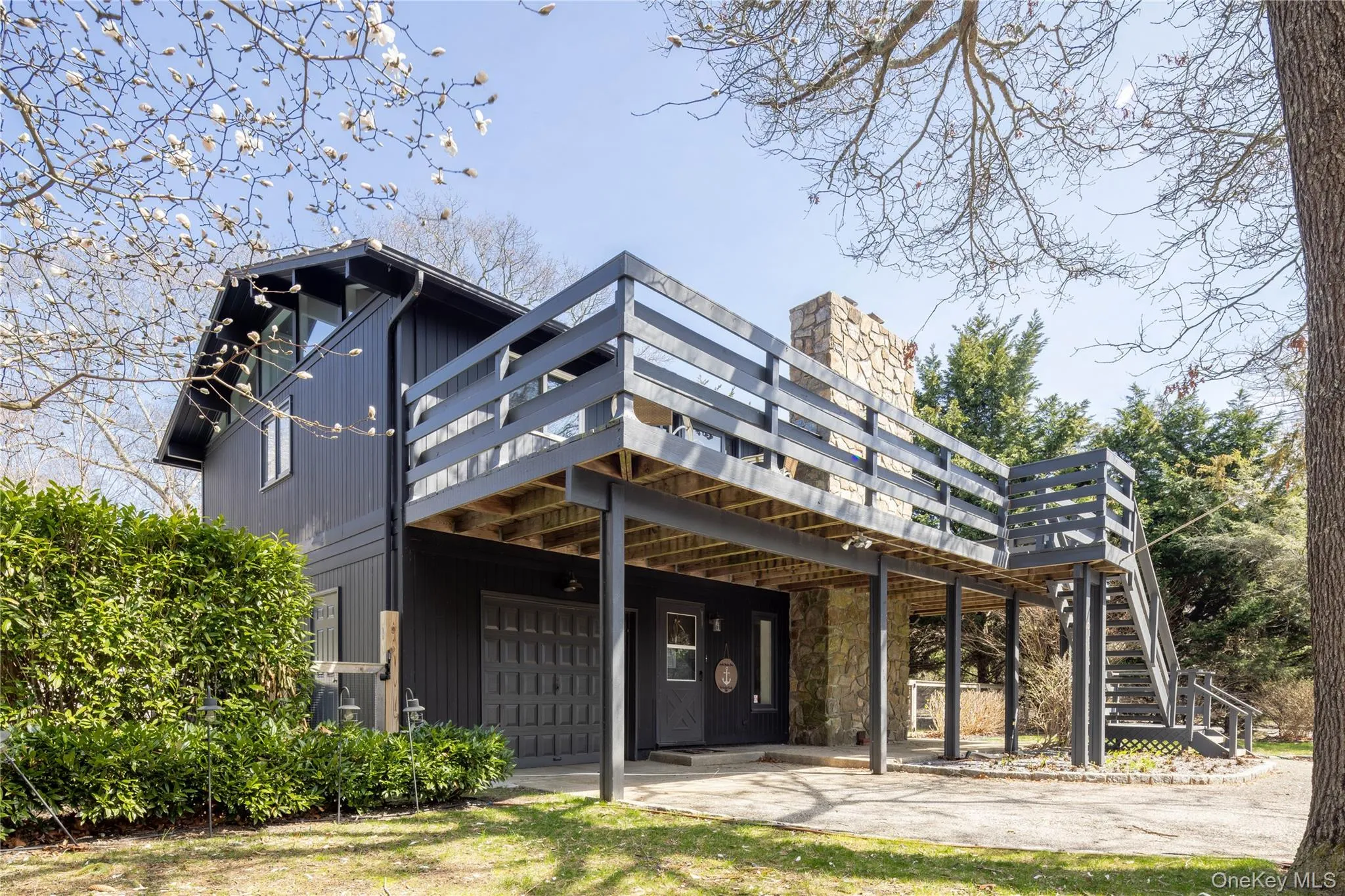 Rear view of property featuring a garage and stairs Rear view of property featuring a garage and stairs