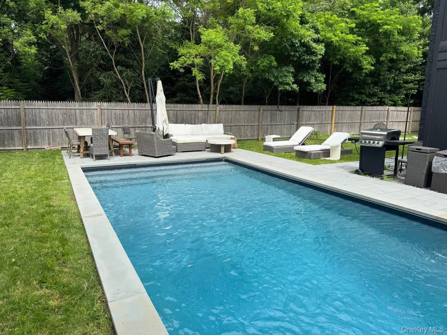 View of pool with outdoor lounge area, a fenced backyard, a patio, grilling area, and outdoor dining space View of pool with outdoor lounge area, a fenced backyard, a patio, grilling area, and outdoor dining space