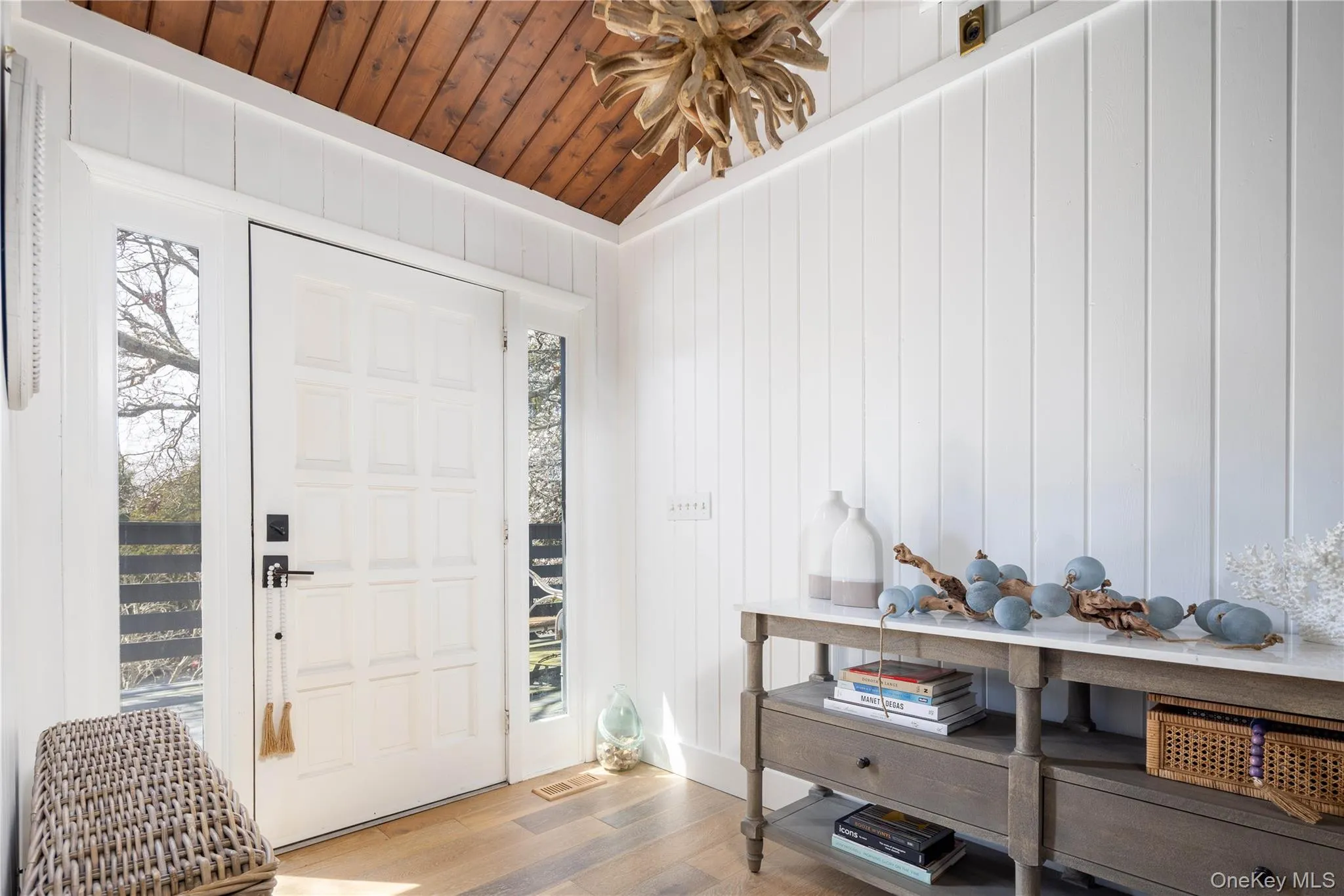Foyer with wood finished floors, lofted ceiling, wooden ceiling, and wood walls Foyer with wood finished floors, lofted ceiling, wooden ceiling, and wood walls