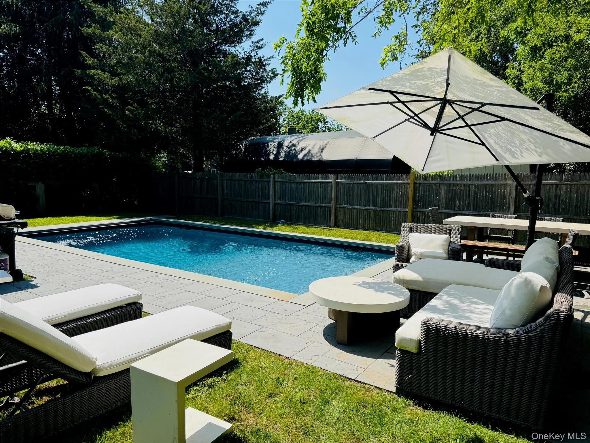 View of pool with a fenced backyard, a patio area, and outdoor lounge area View of pool with a fenced backyard, a patio area, and outdoor lounge area