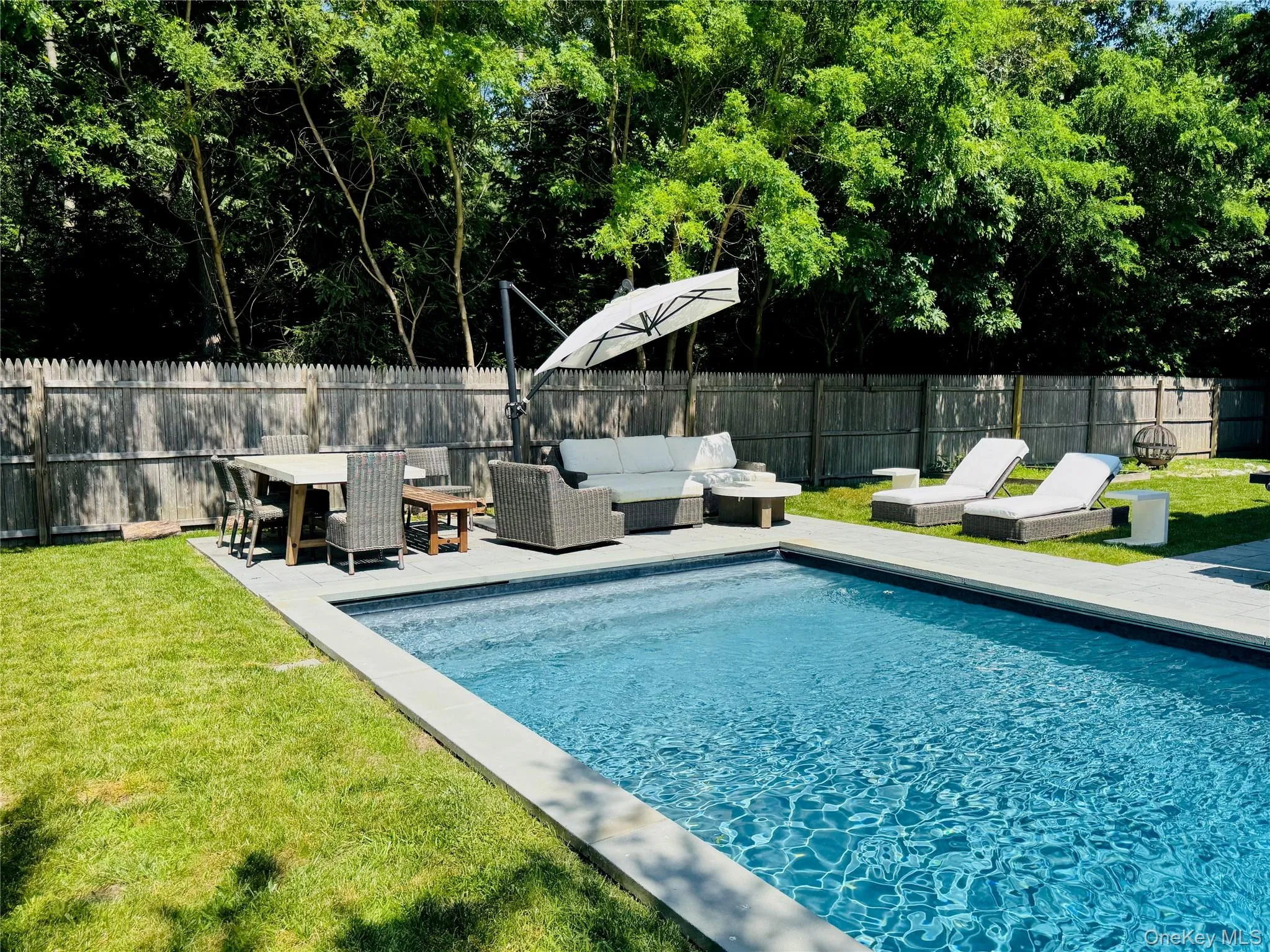 View of pool featuring a fenced backyard, a patio area, and an outdoor living space View of pool featuring a fenced backyard, a patio area, and an outdoor living space