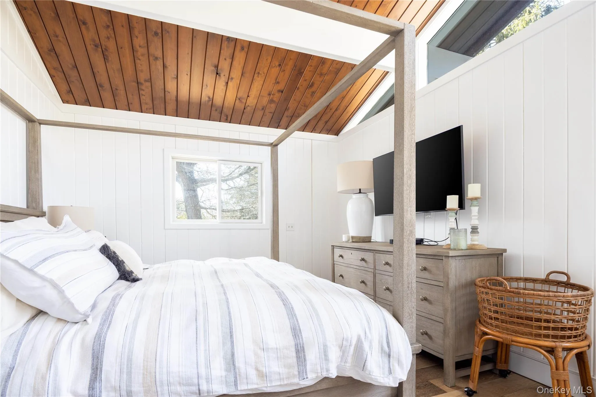 Bedroom with wooden walls, wood ceiling, and wood finished floors Bedroom with wooden walls, wood ceiling, and wood finished floors