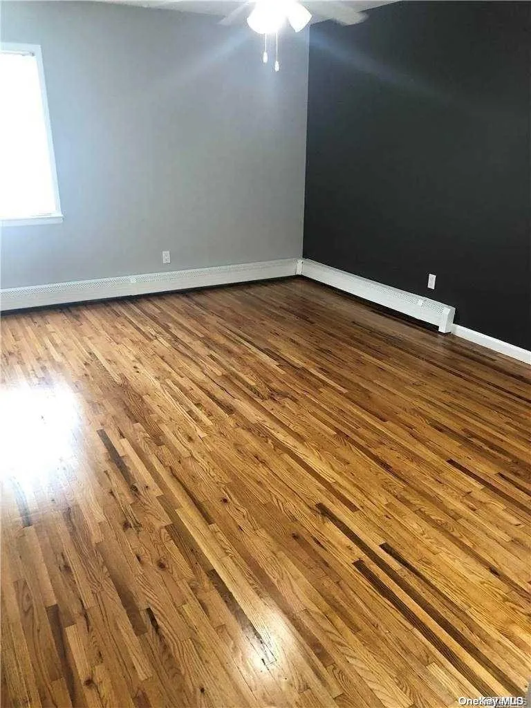 Empty room featuring hardwood / wood-style flooring Empty room featuring hardwood / wood-style flooring