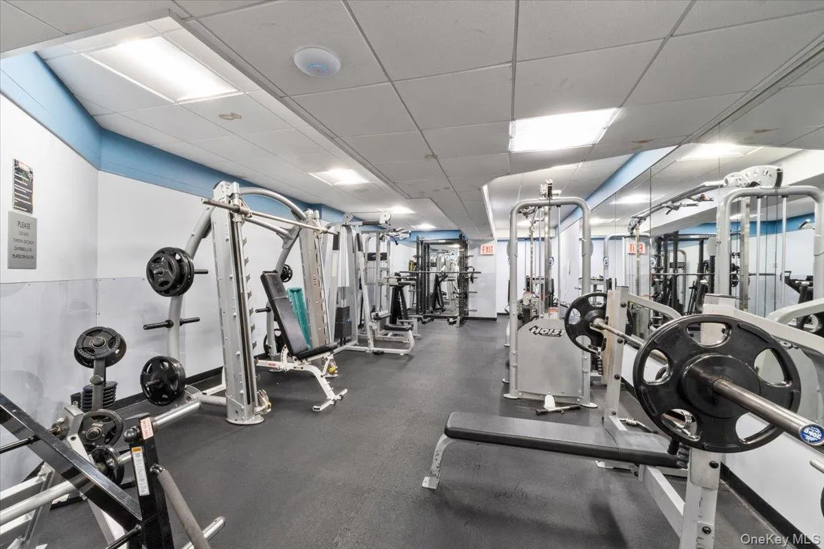 Gym featuring a drop ceiling Gym featuring a drop ceiling