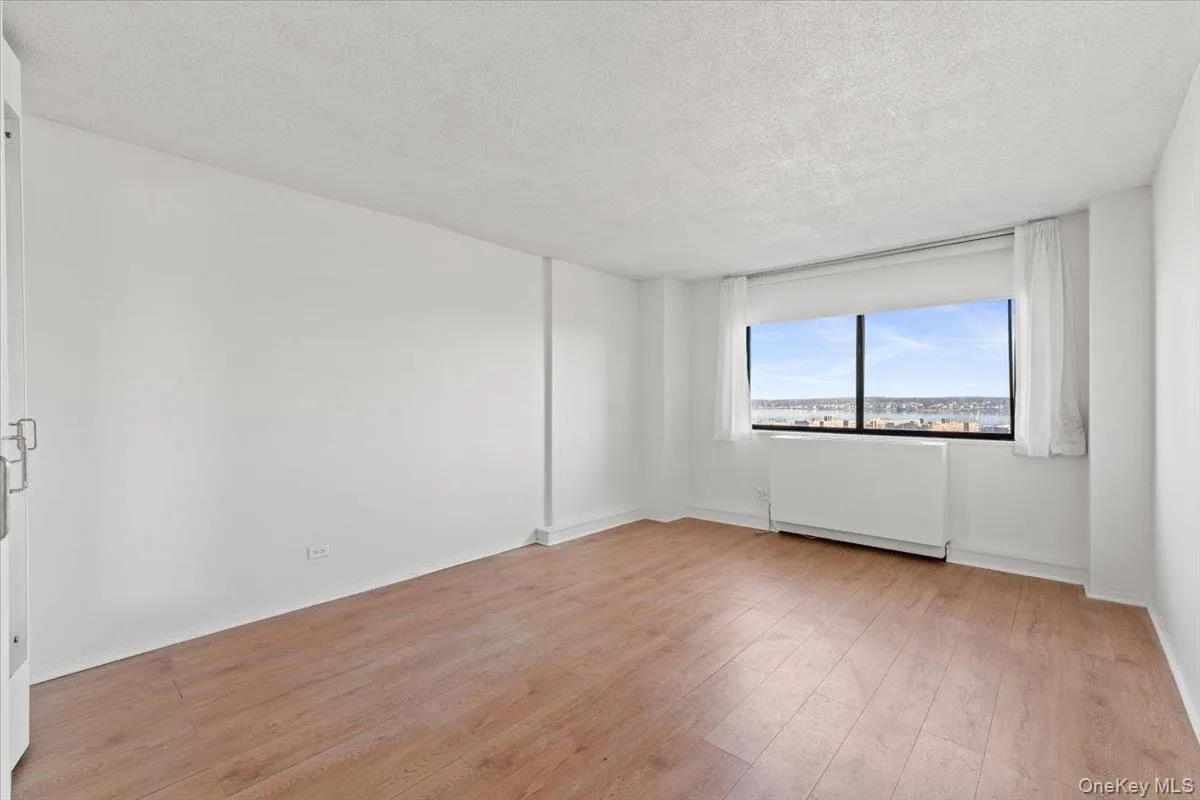 Spare room with a textured ceiling and light wood-style floors Spare room with a textured ceiling and light wood-style floors