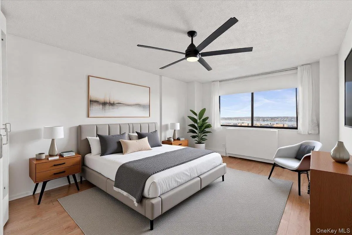Virtually Staged Bedroom with light wood-type flooring, a ceiling fan, and a textured ceiling Virtually Staged Bedroom with light wood-type flooring, a ceiling fan, and a textured ceiling