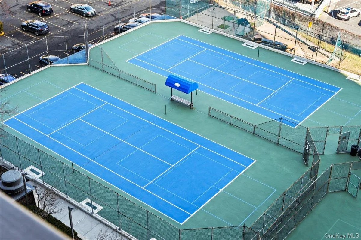 View of tennis court featuring community basketball court View of tennis court featuring community basketball court