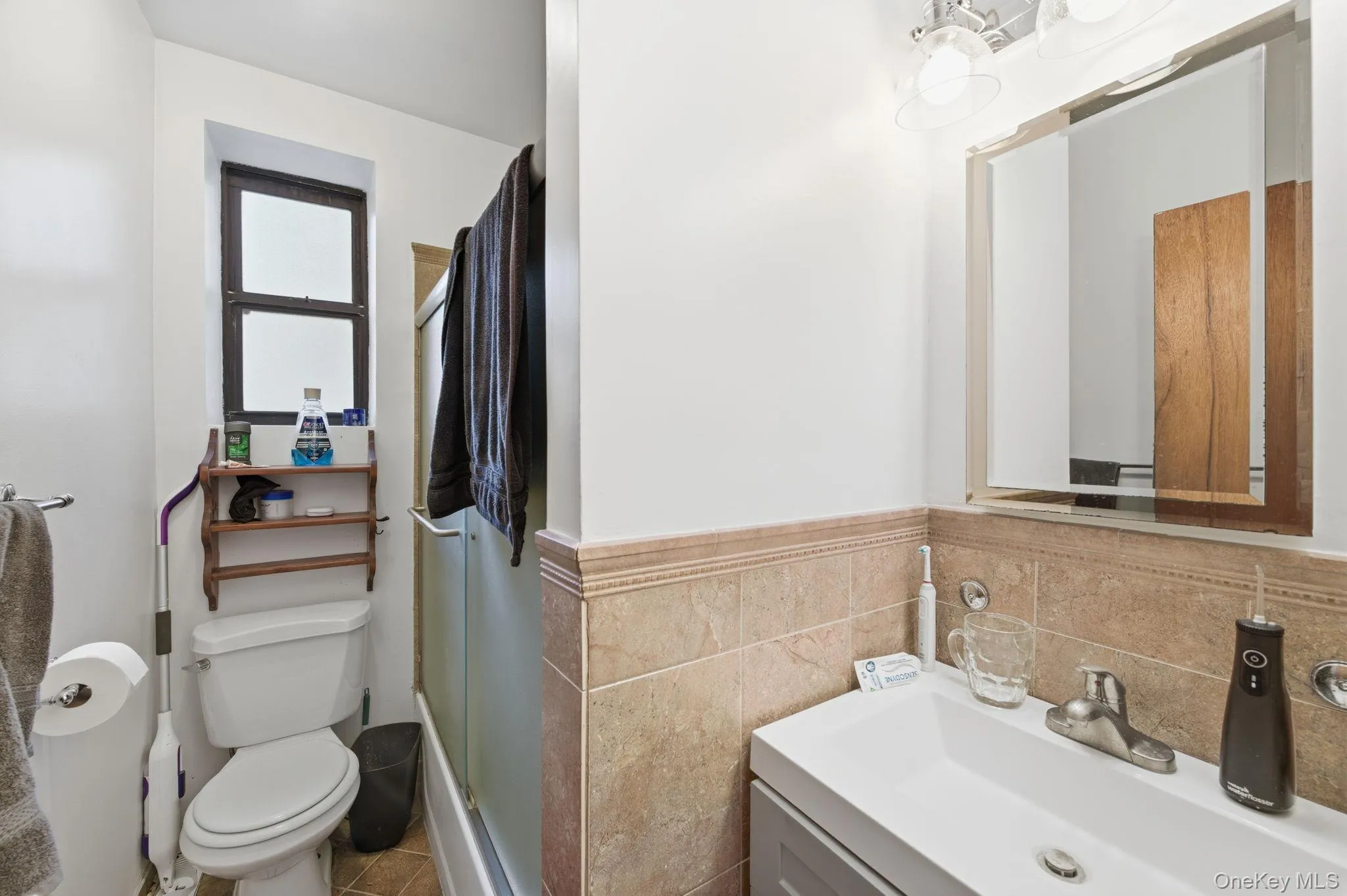 Full bath featuring vanity, a stall shower, and tile walls Full bath featuring vanity, a stall shower, and tile walls